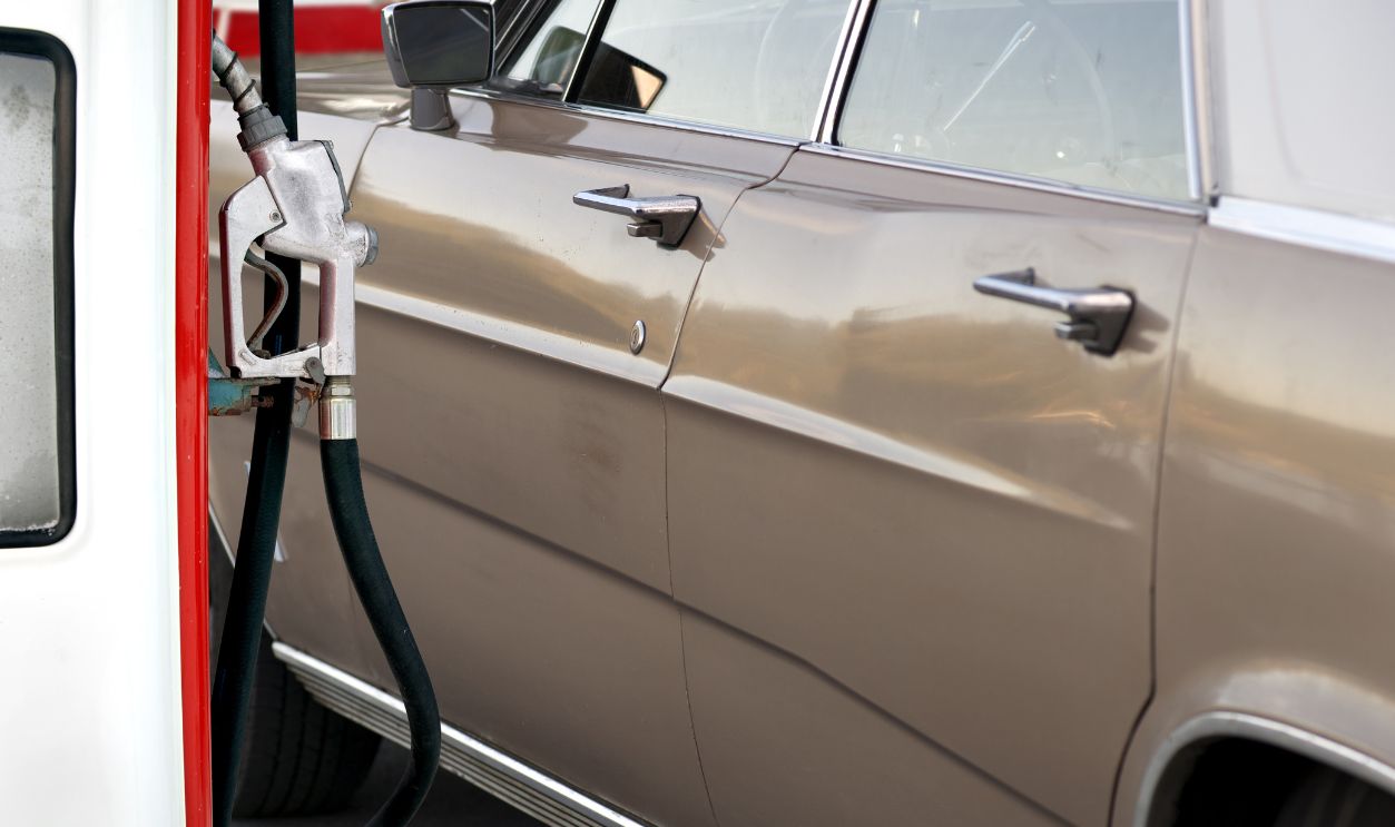 Vintage car at gas station, ready to be filled up