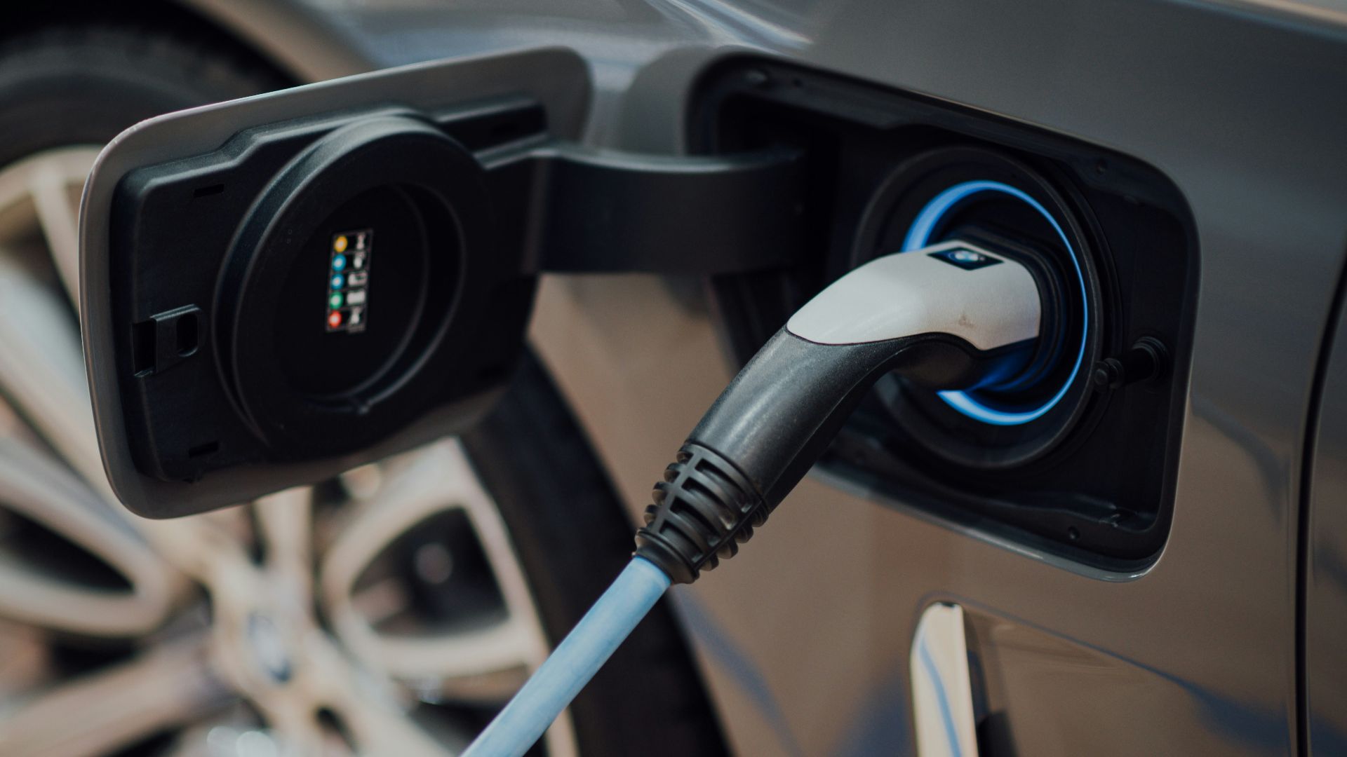 electric vehicle charging cable plugged into car