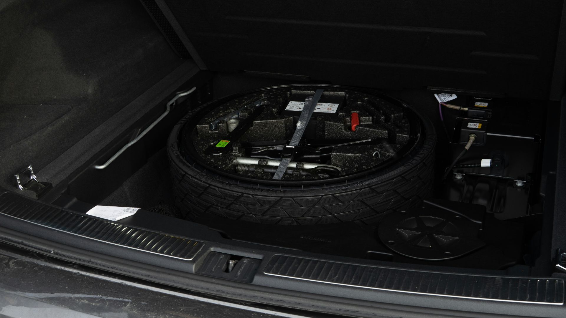 Spare tire and tools in car trunk