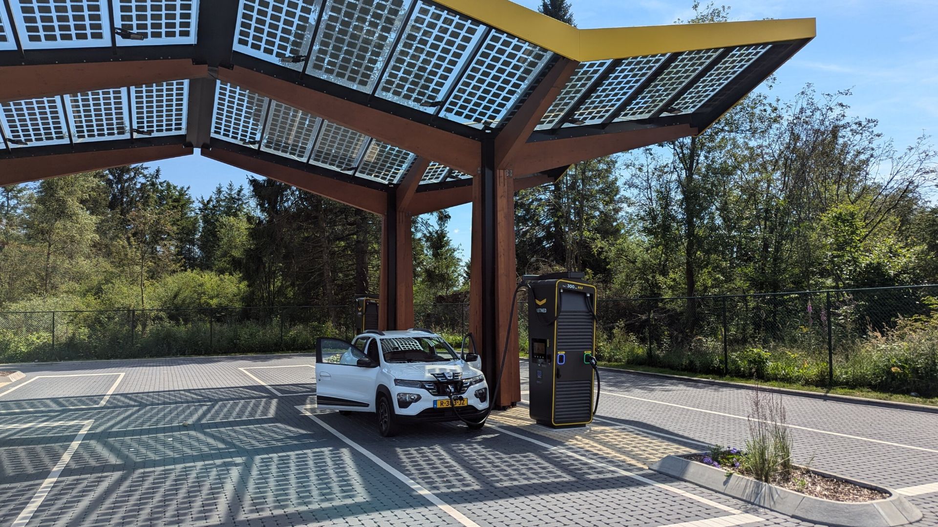 A white Dacia Spring at a Fastned Fast Charger in Belgium