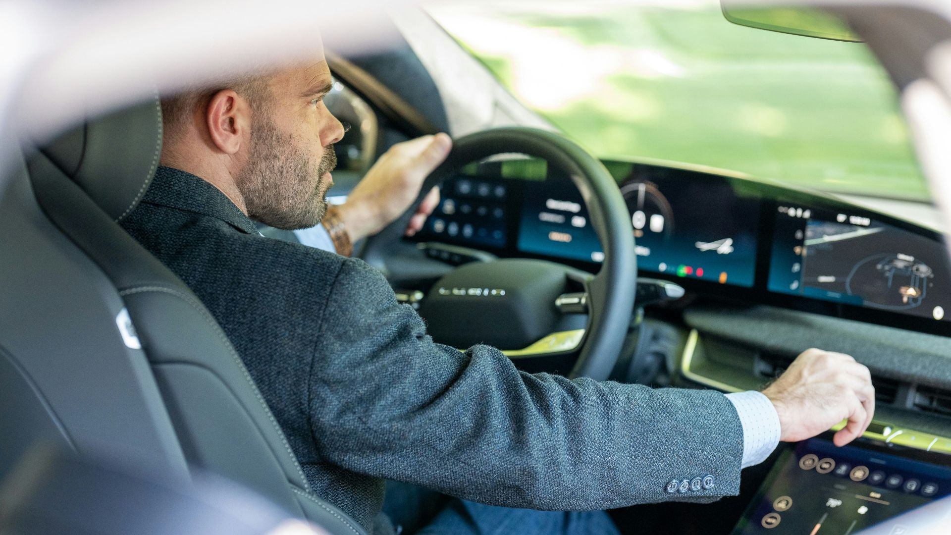 a man in a suit driving a car
