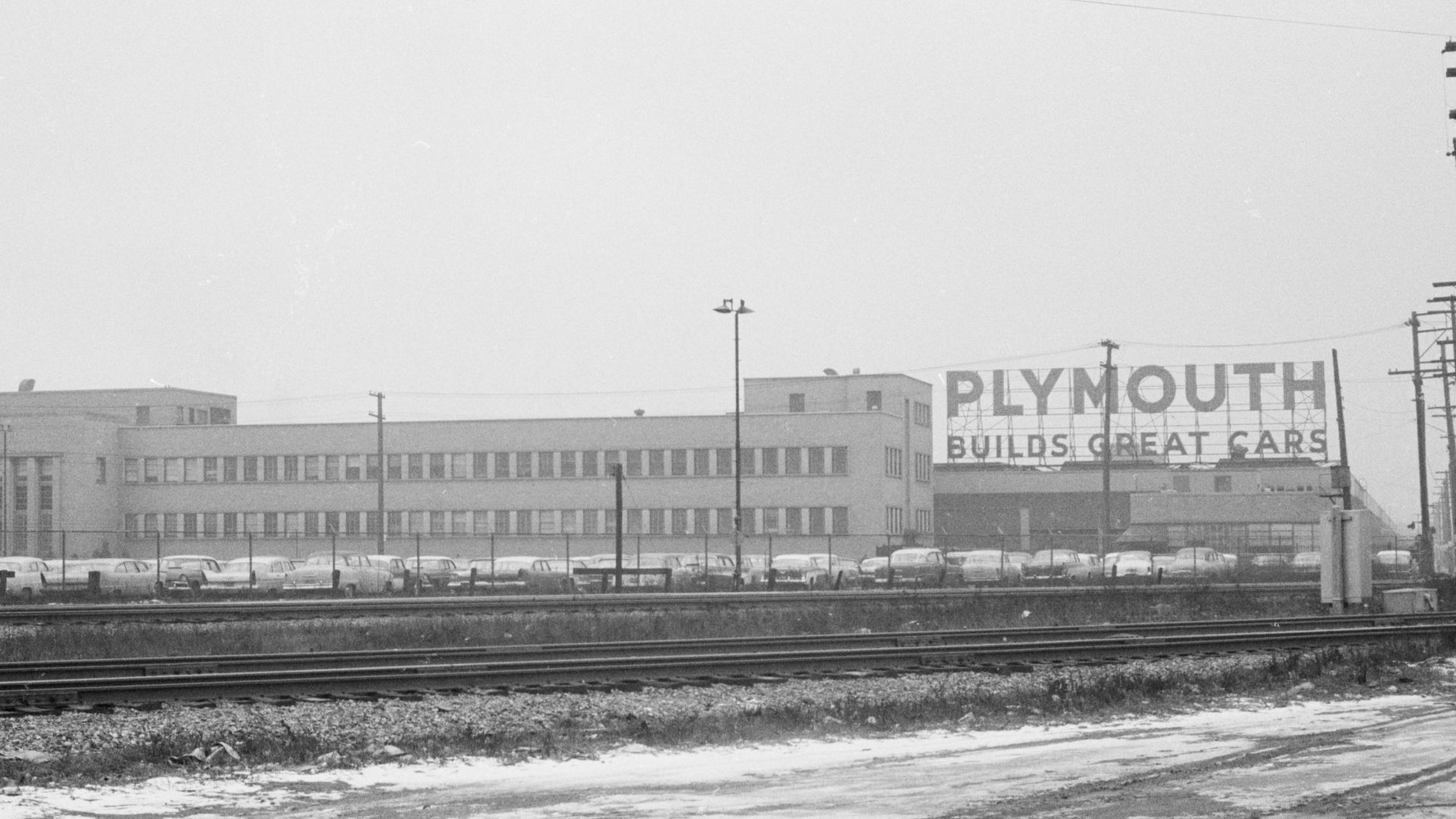 Exterior view of a Plymouth automobile factory with sign 'Plymouth builds great cars', Detroit, Michigan