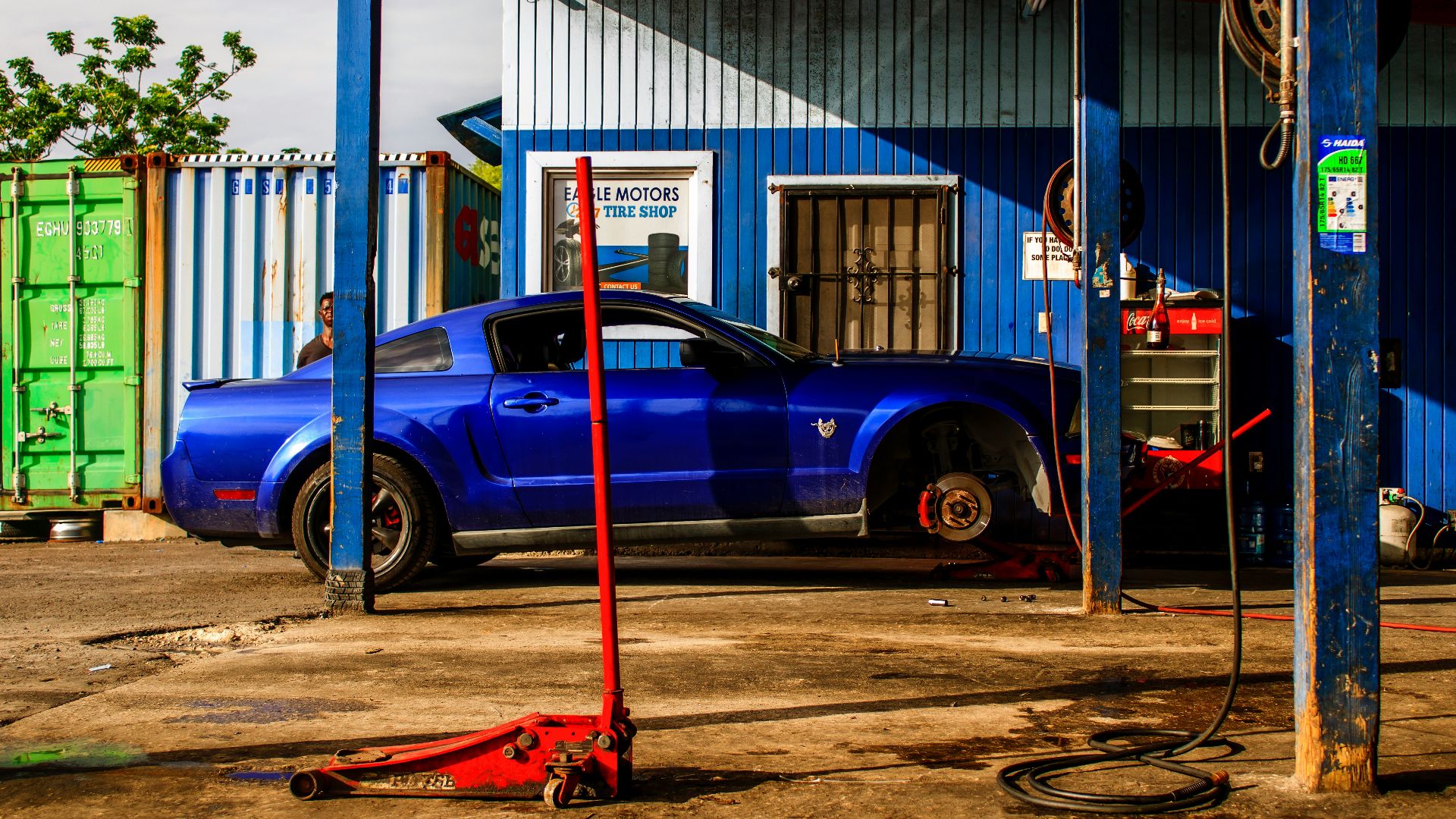 a blue car parked in front of a building