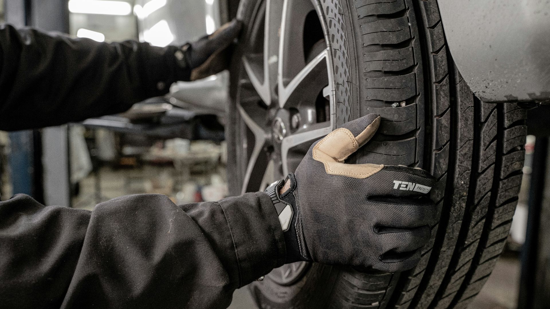 a man working on a tire in a garage