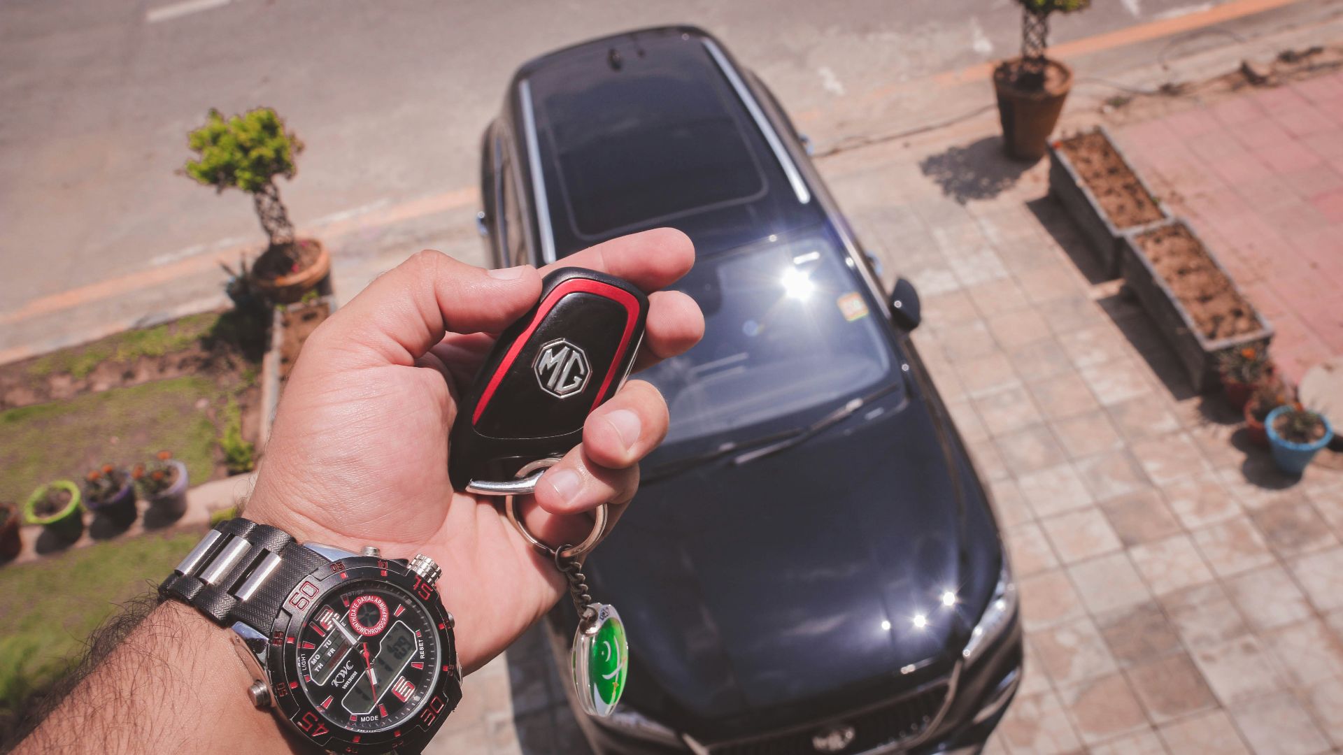 person holding black and red round digital watch