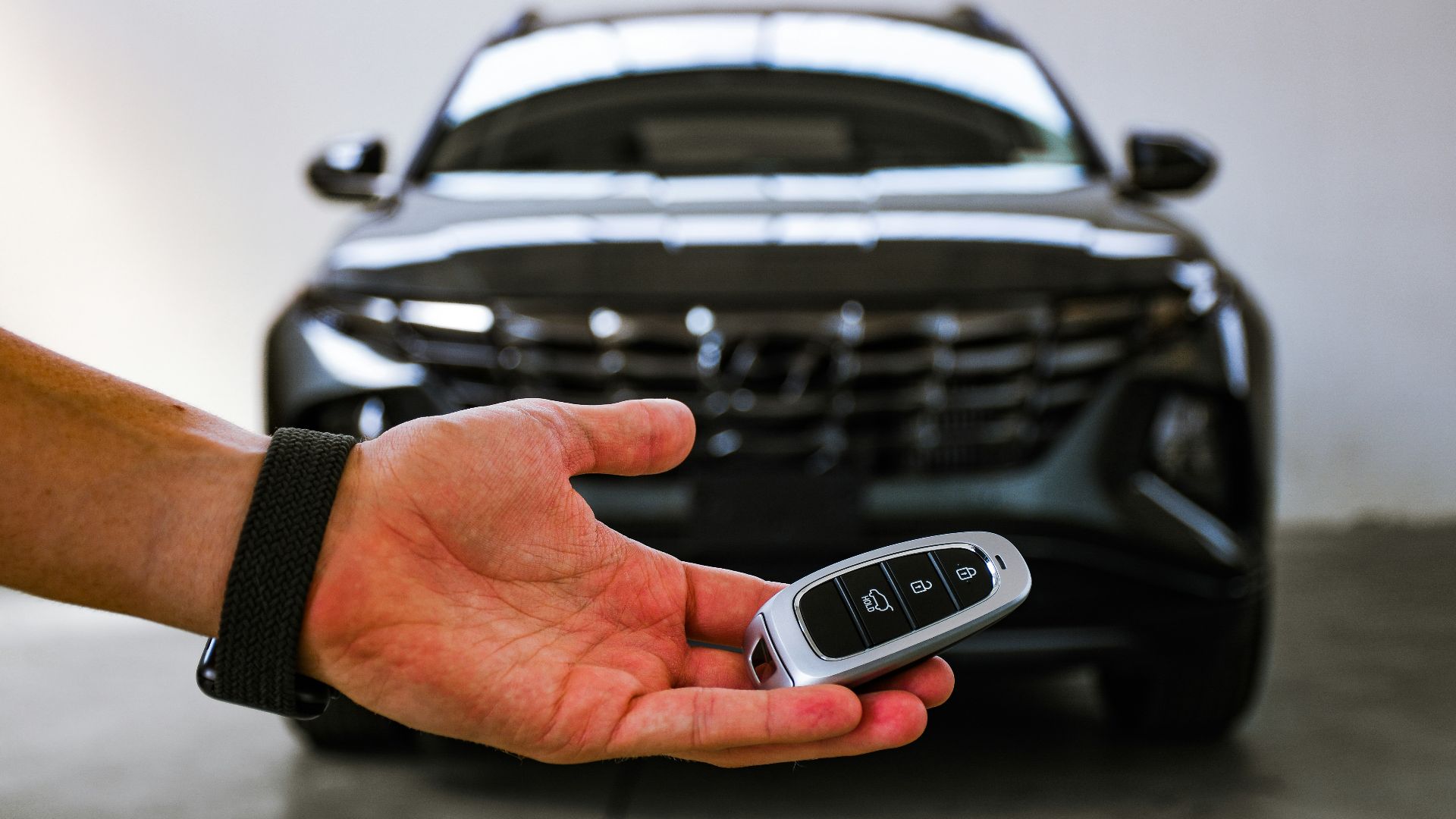 person holding black and silver audi car steering wheel