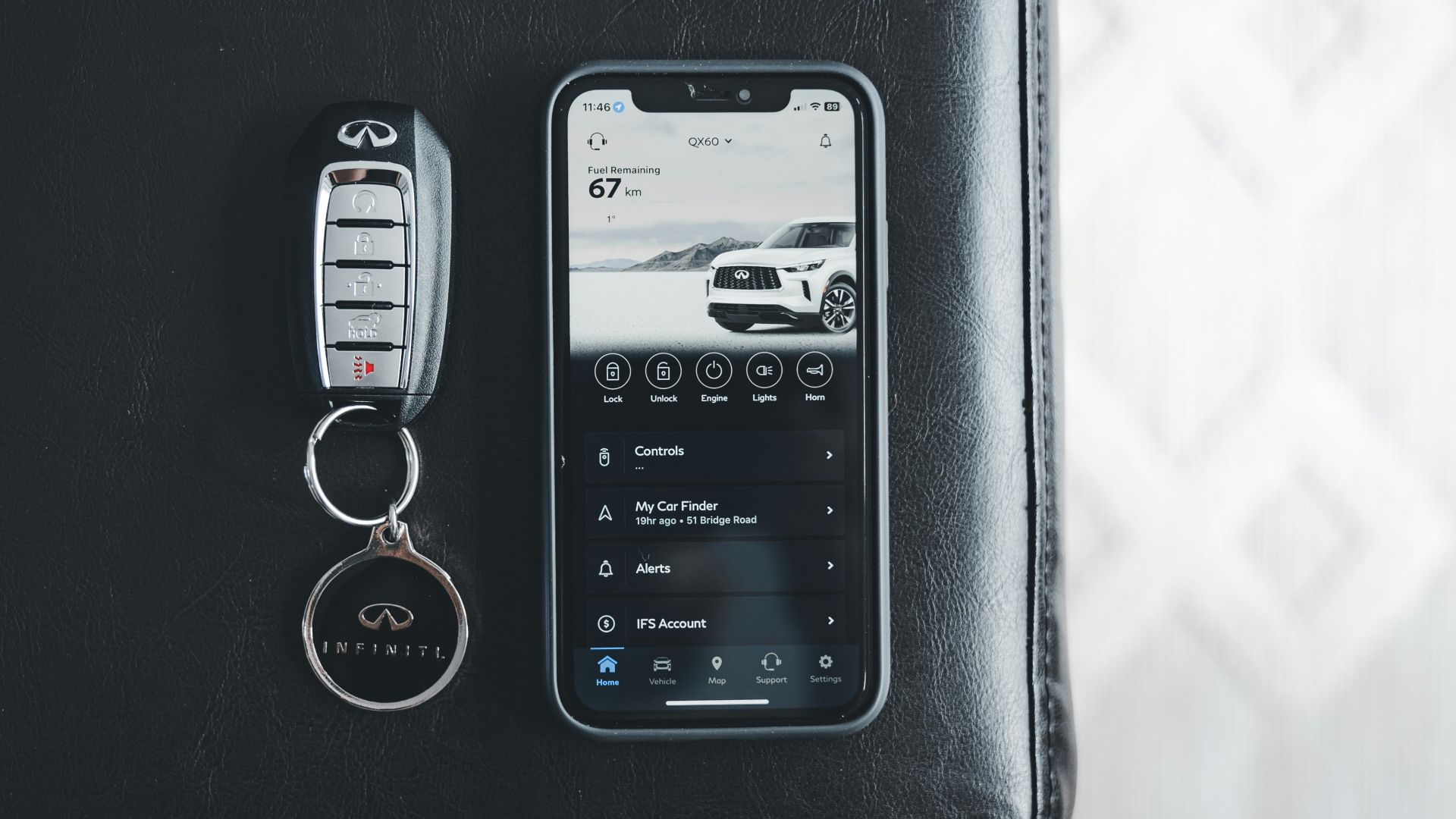 a cell phone sitting next to a car keychain