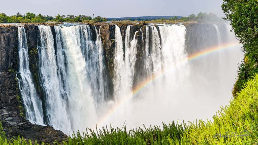Photo of the Victoria Falls in Zimbabwe, with rainbow in front