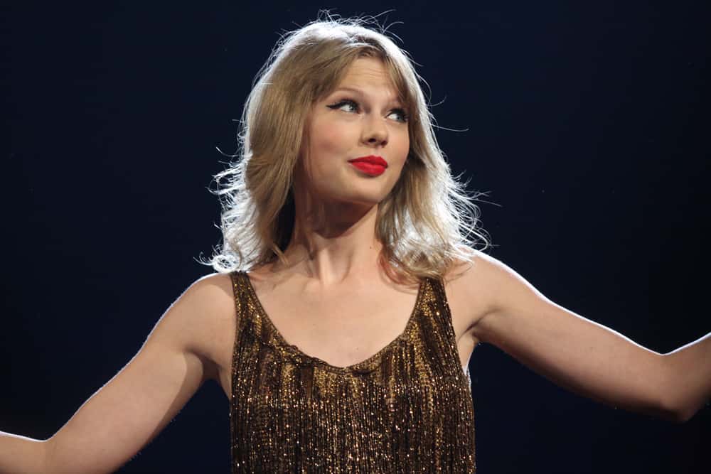 Taylor Swift during the Speak Now Tour in Sydney, Australia, wearing a shiny dress, looking to the right