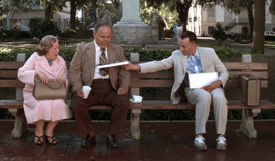 Tom Hanks as Forrest Gump wearing blue plaid shirt 