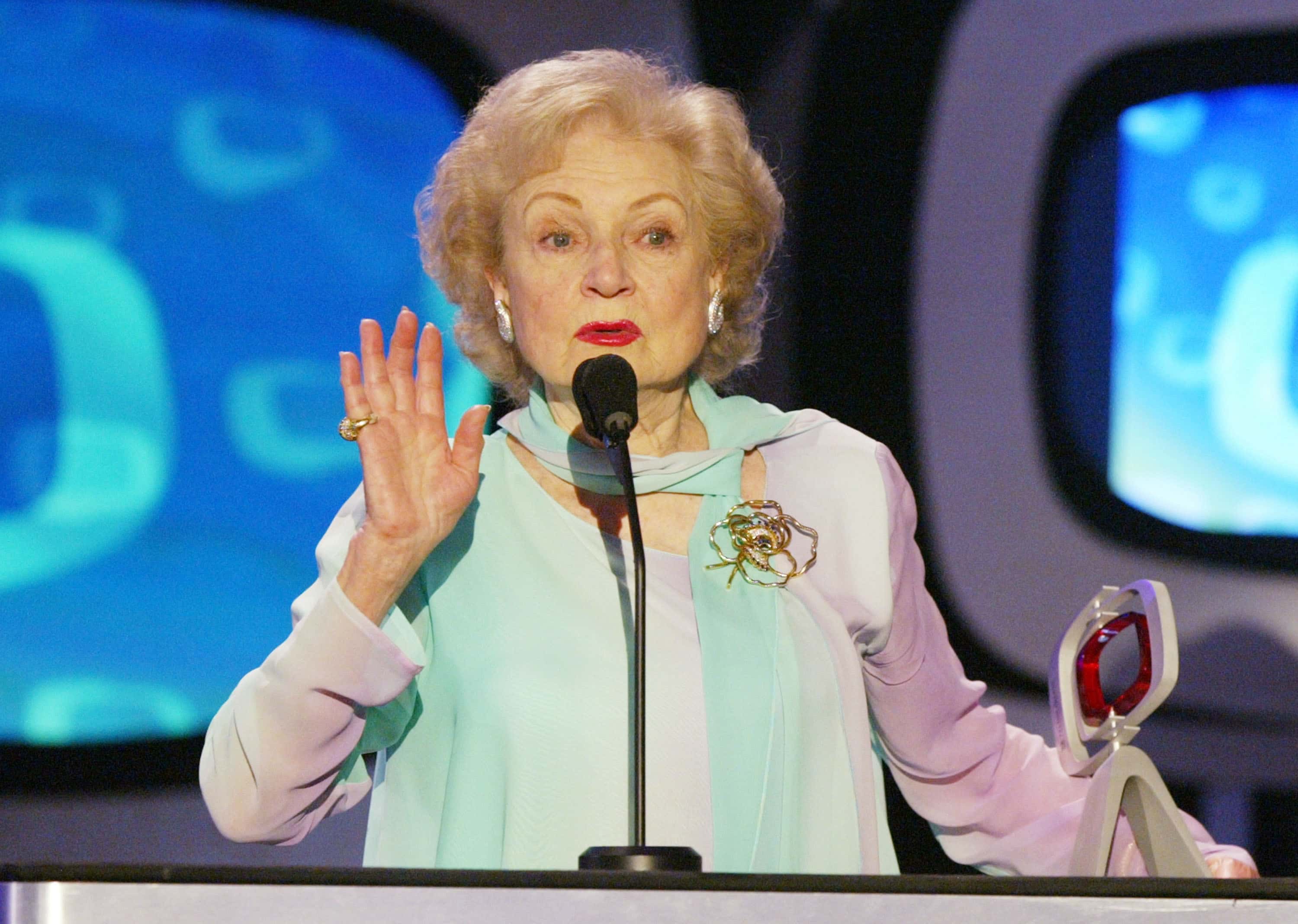  Actress Betty White speaks on stage in blue top 