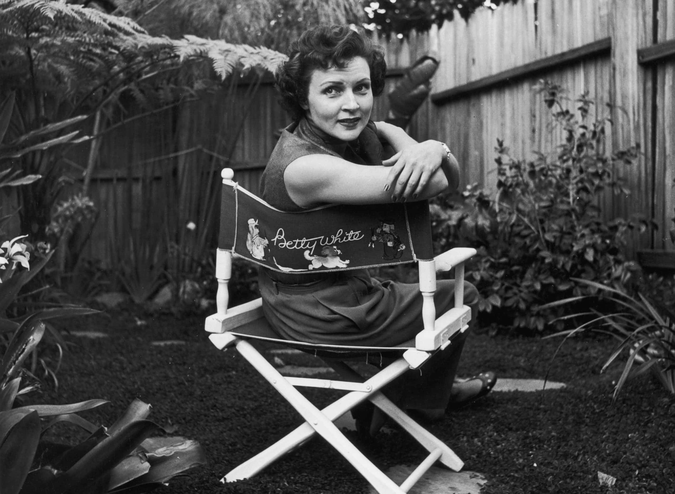American actor Betty White sits in a canvas chair