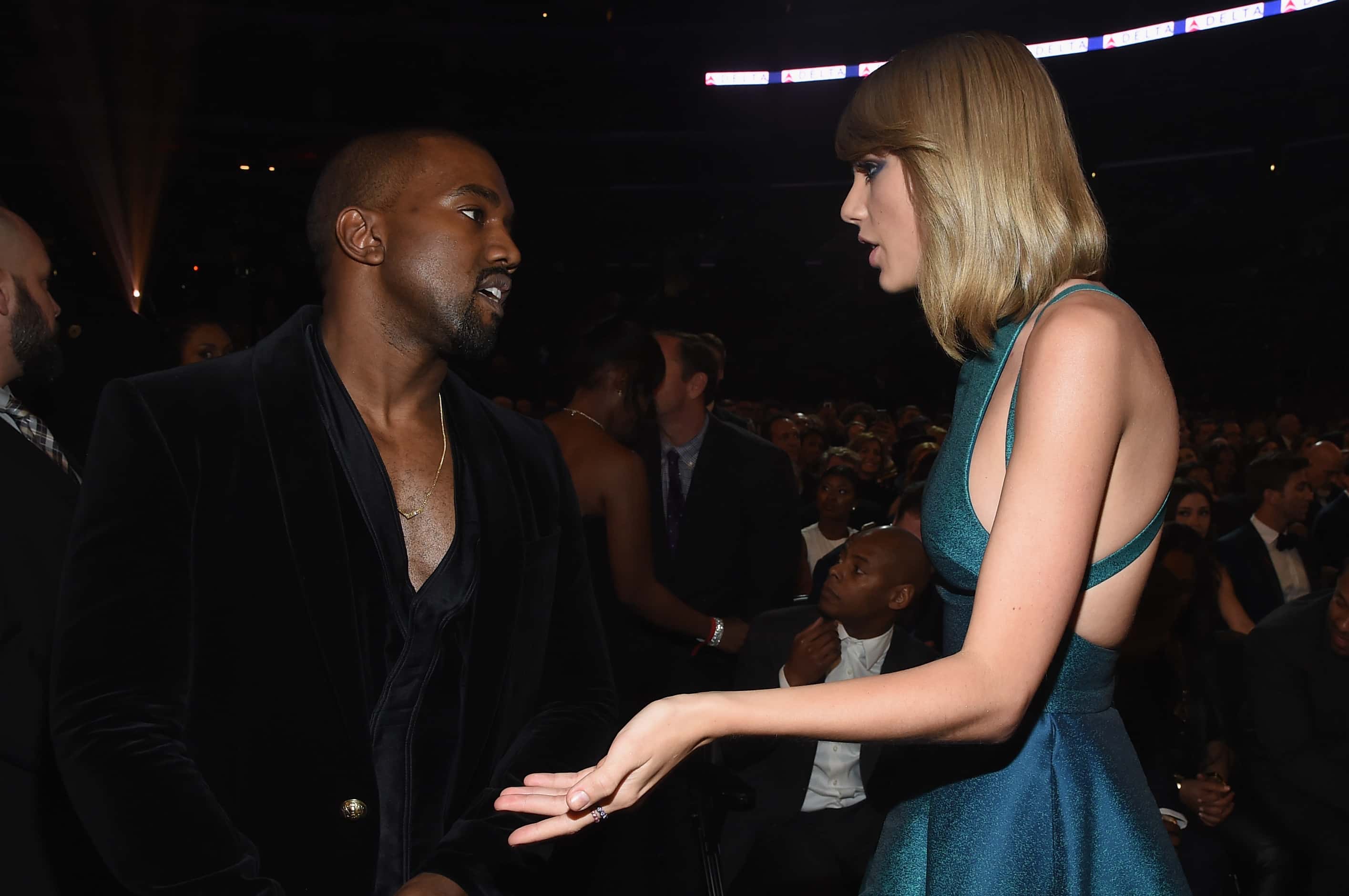 Recording Artists Kanye West and Taylor Swift attend The 57th Annual GRAMMY Awards at the STAPLES Center, talking to each other
