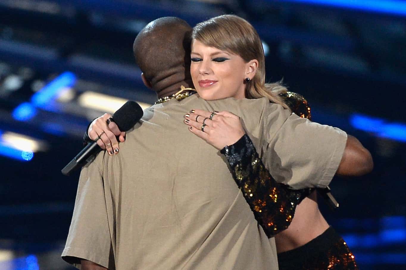 Recording artist Kanye West accepts the Video Vanguard Award from recording artist Taylor Swift onstage during the MTV Video Music Awards