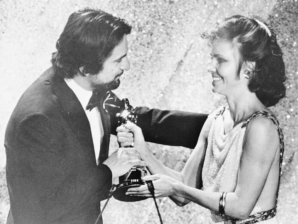 (Original Caption) March 31, 1981 - Hollywood: Actress Sally Fields presents an Oscar to actor Robert De Niro for his role in