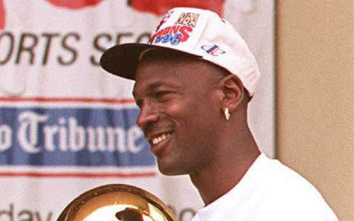 Michael Jordan (R) hold three of the team's four recent Larry O'Brien trophies 18 June
