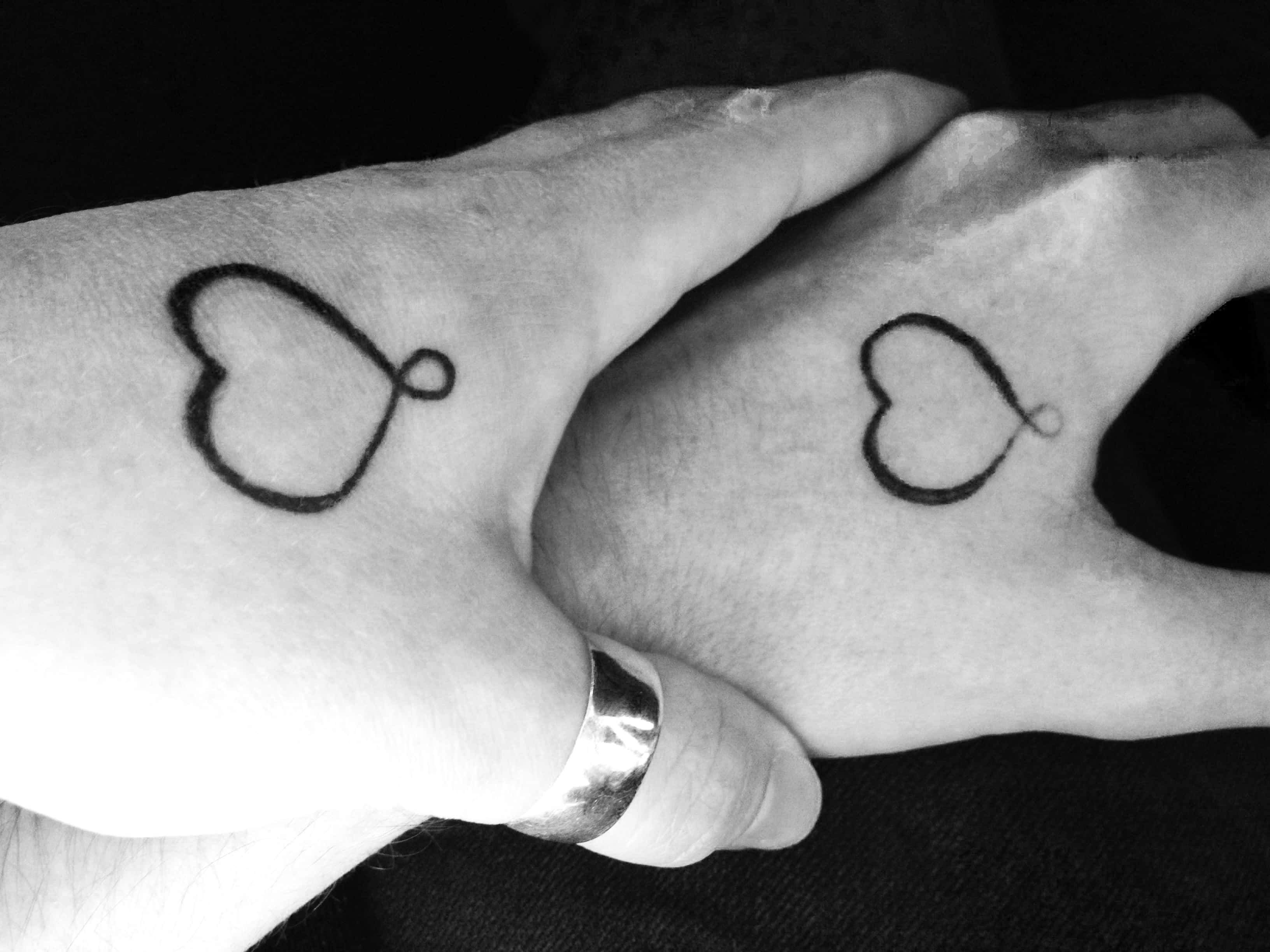 Permanent. Couple holding hands in black'n white.