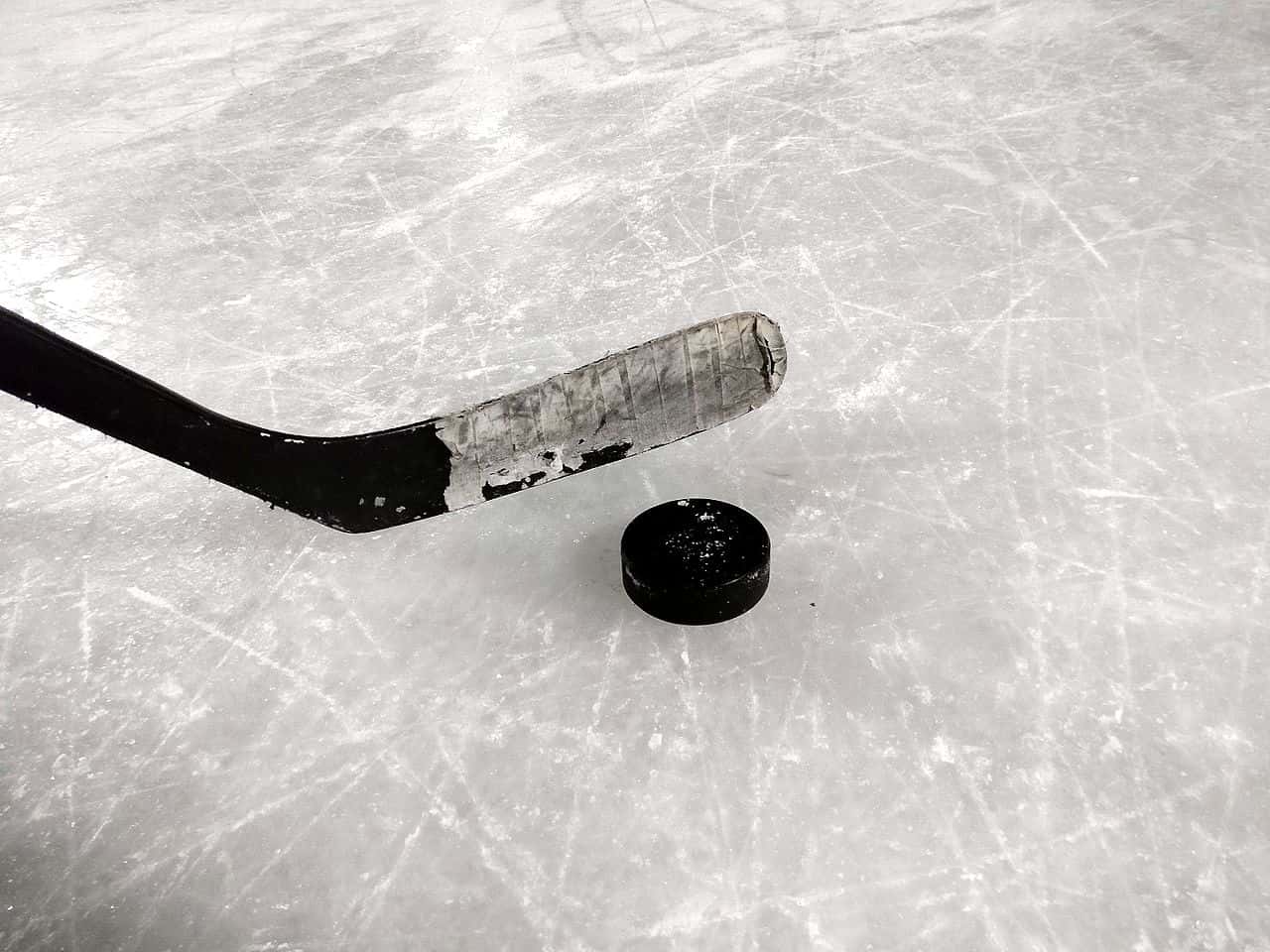 Photography of an Ice hockey stick and puck