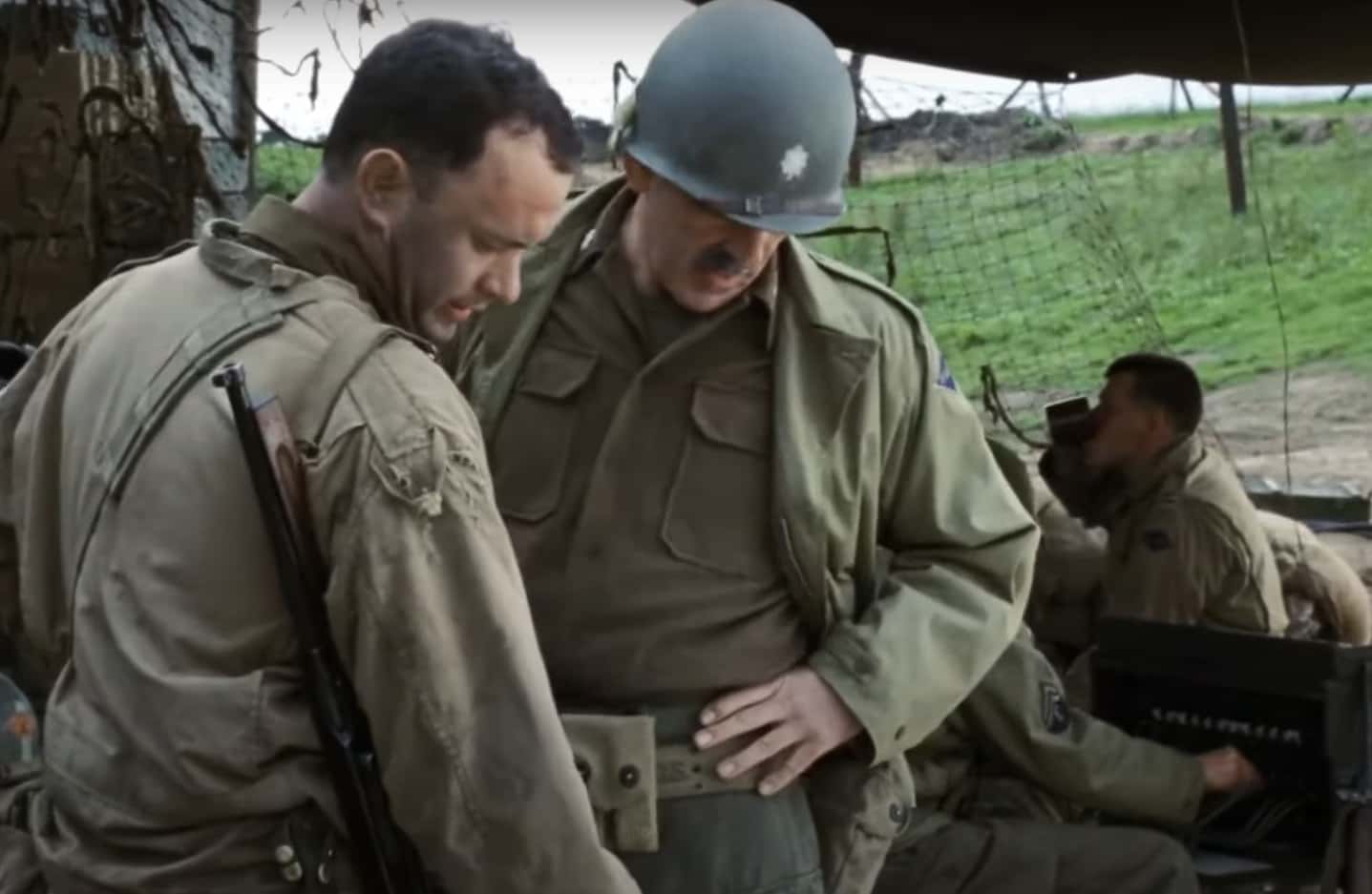 Screenshot of (Tom Hanks) Captain Miller talking outside - from Saving Private Ryan (1998)