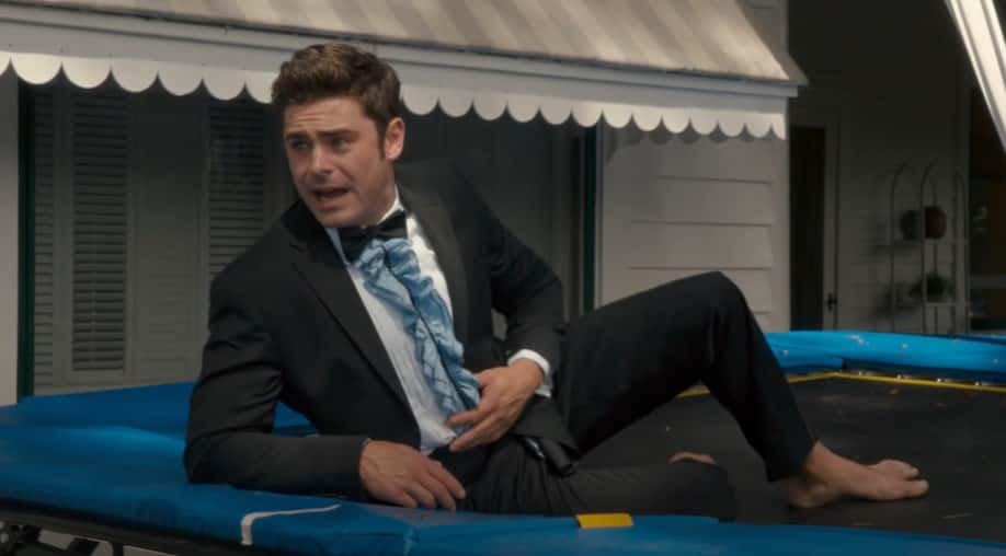 Screenshot of the Actor Zac Efron from the movie Mike and Dave Need Wedding Dates wearing a black suit