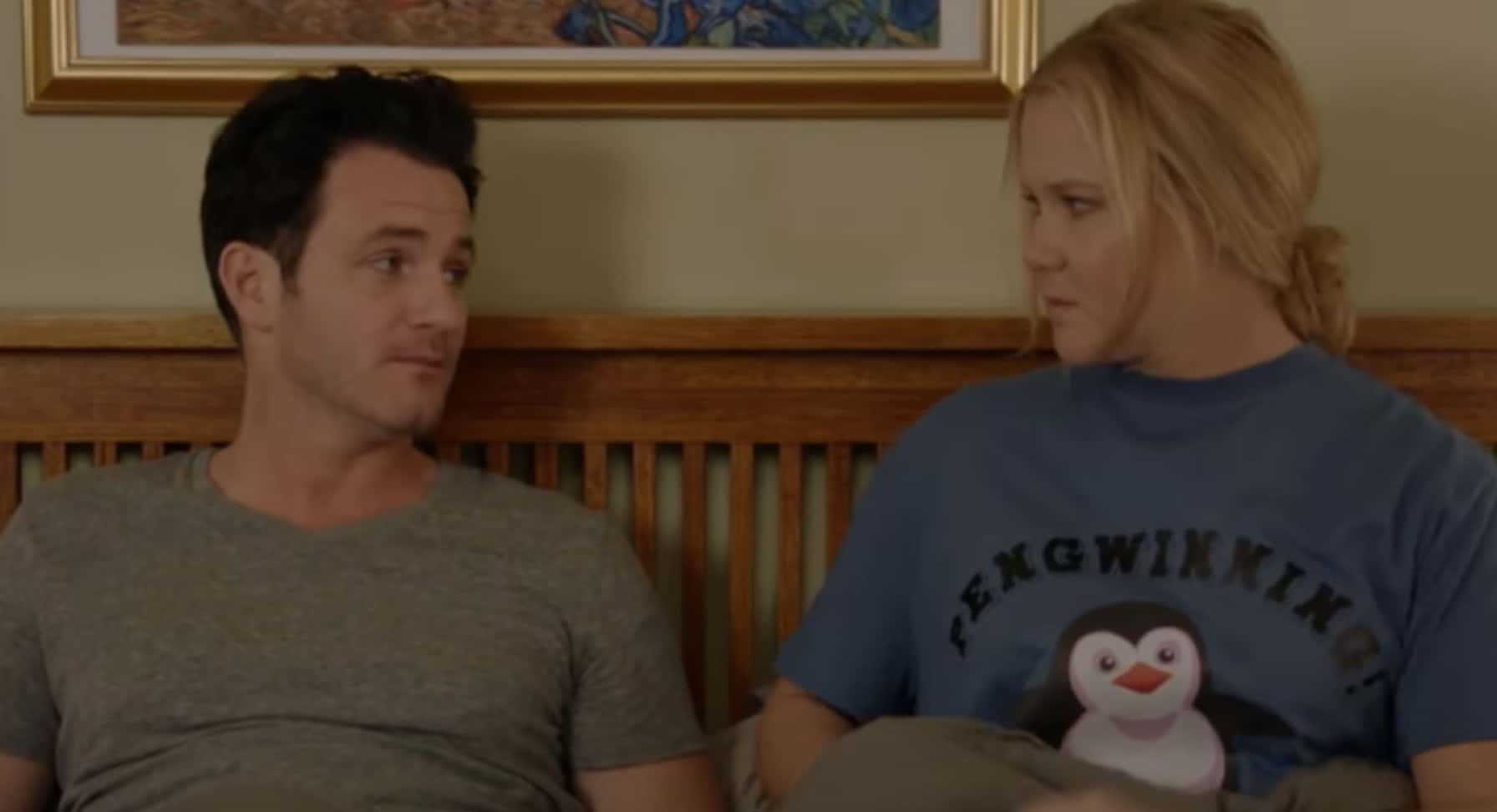 Amy Schumer in her show sitting on bed