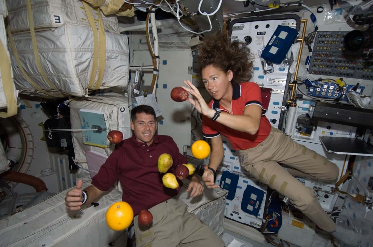 astronauts on a spacecraft mission floating weightlessly