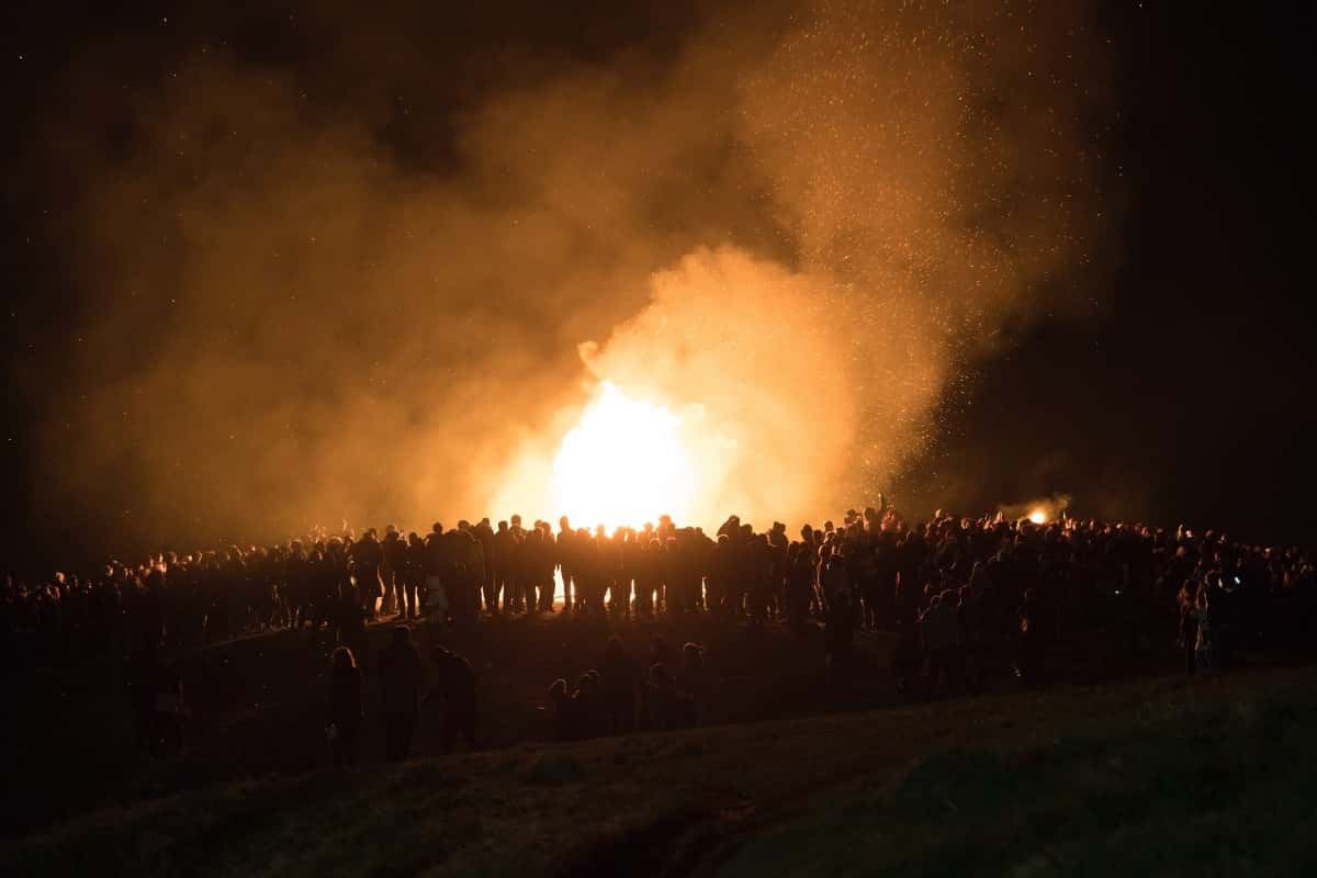 photo of silhouette, gathering, people, sky, night, atmosphere, smoke, crowd, evening, flame, fire, darkness, bonfire