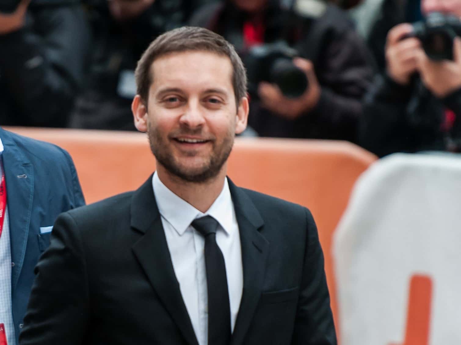 Portrait Photo of Tobey Maguire in a dark suit