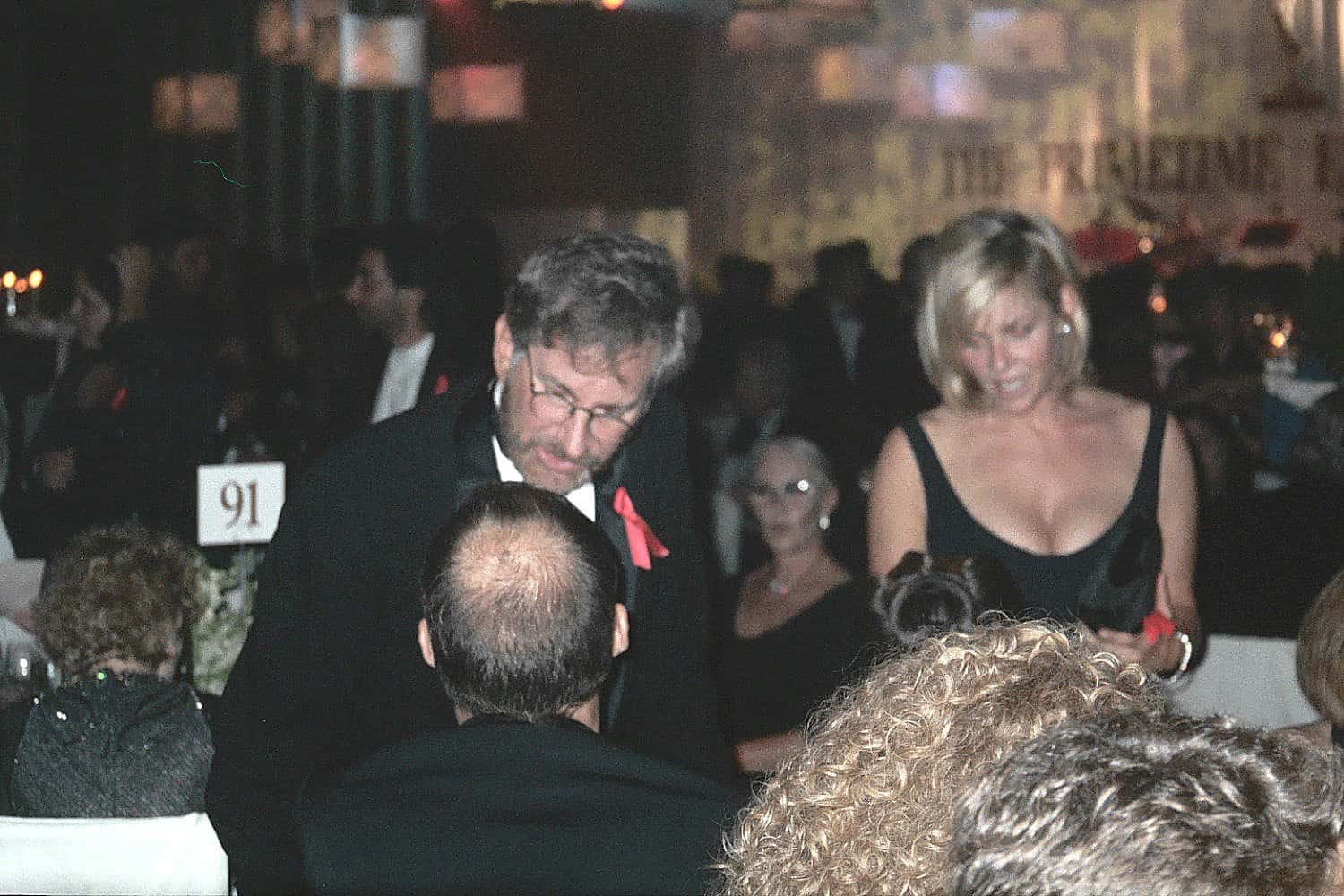 Steven Spielberg, Kate Capshaw in front of a table