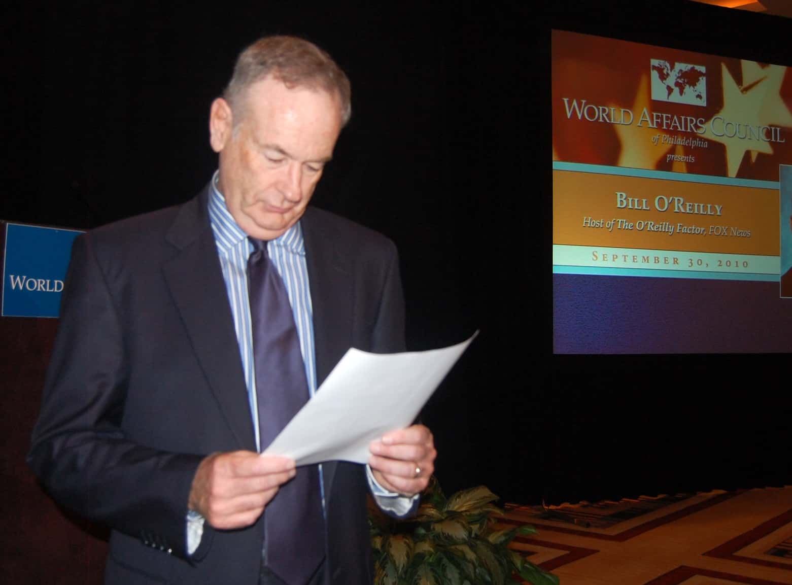 Bill O'Reilly reading papers