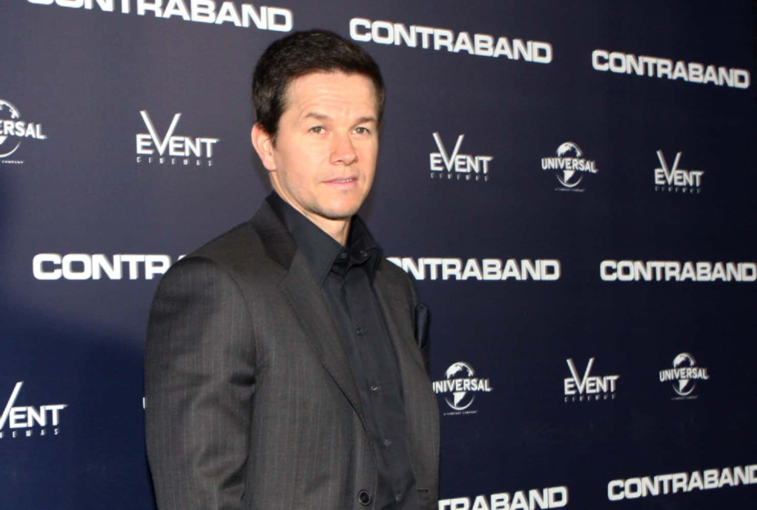 Portrait Photo of Mark Wahlberg in a gray suit, smiling