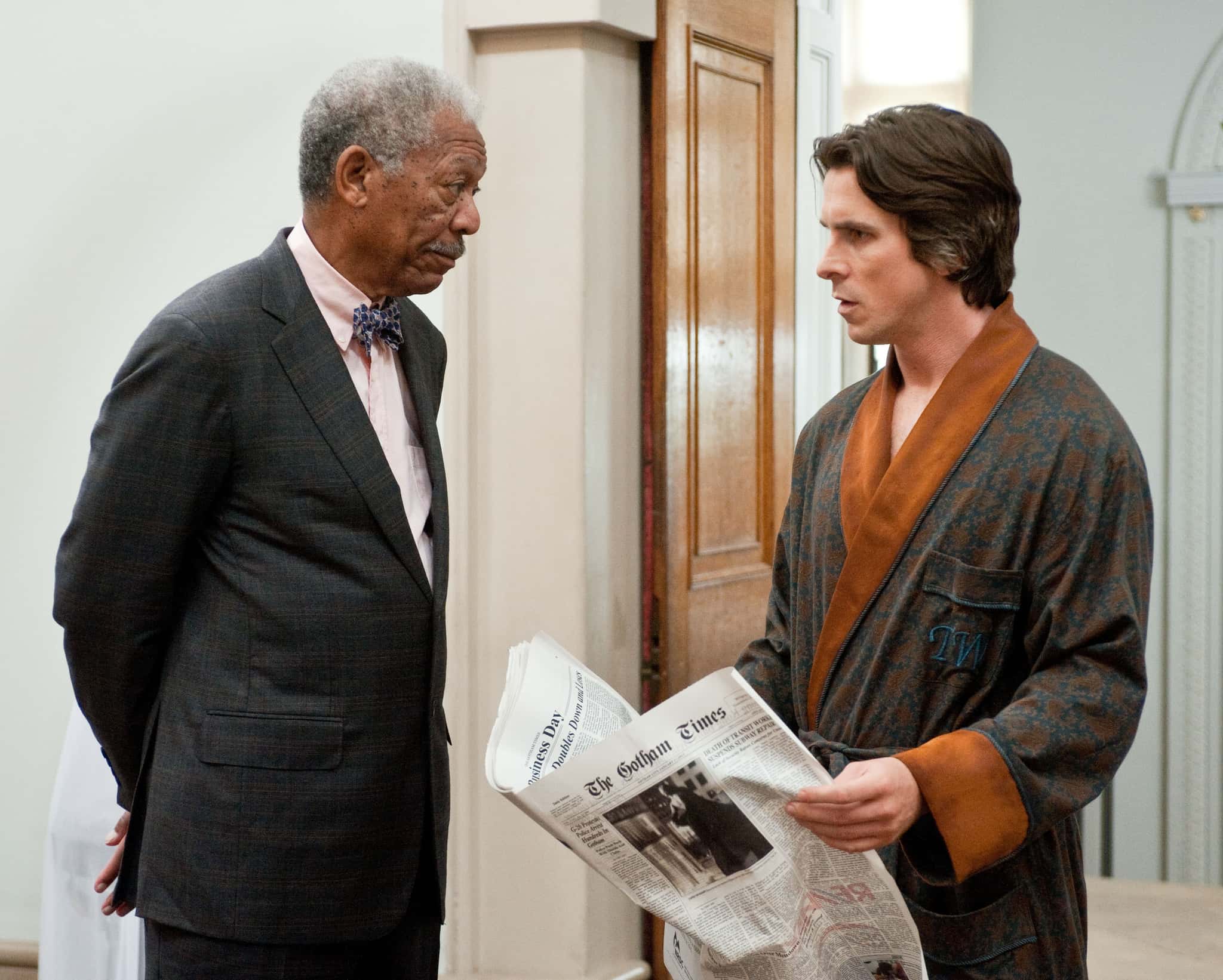MORGAN FREEMAN as Lucius Fox and CHRISTIAN BALE as Bruce Wayne