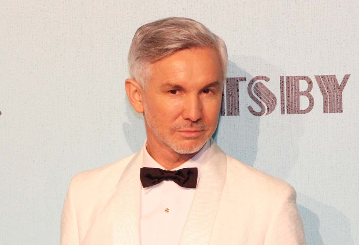 Portrait Photo of Baz Luhrmann in a white suit