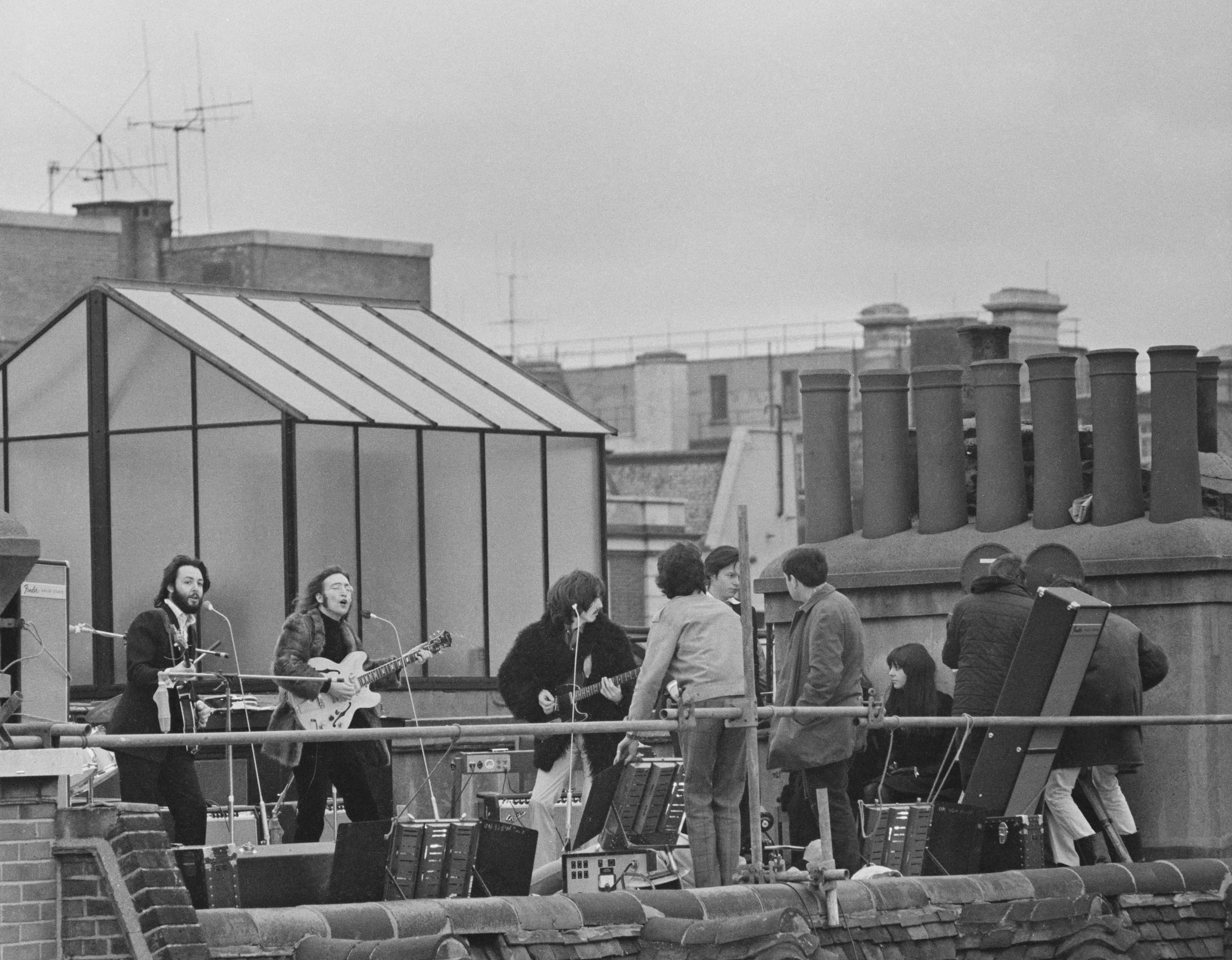 British rock group the Beatles performing their last live public concert on the rooftop of the Apple Organization building for director Michael Lindsey-Hogg's film documentary, 'Let It Be,' on Savile Row, London, UK, 30th January 1969