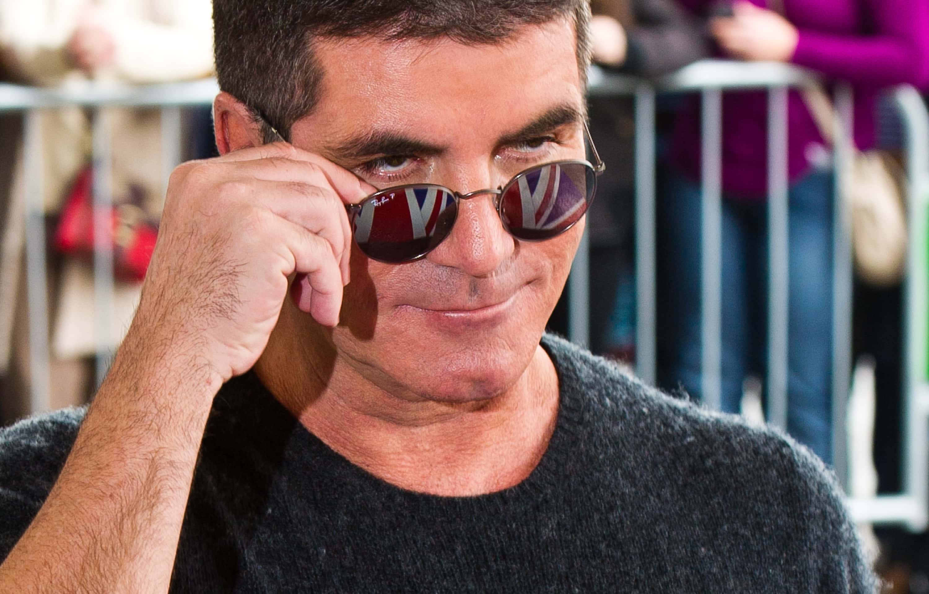 Simon Cowell in gray t-shirt and sunglasses