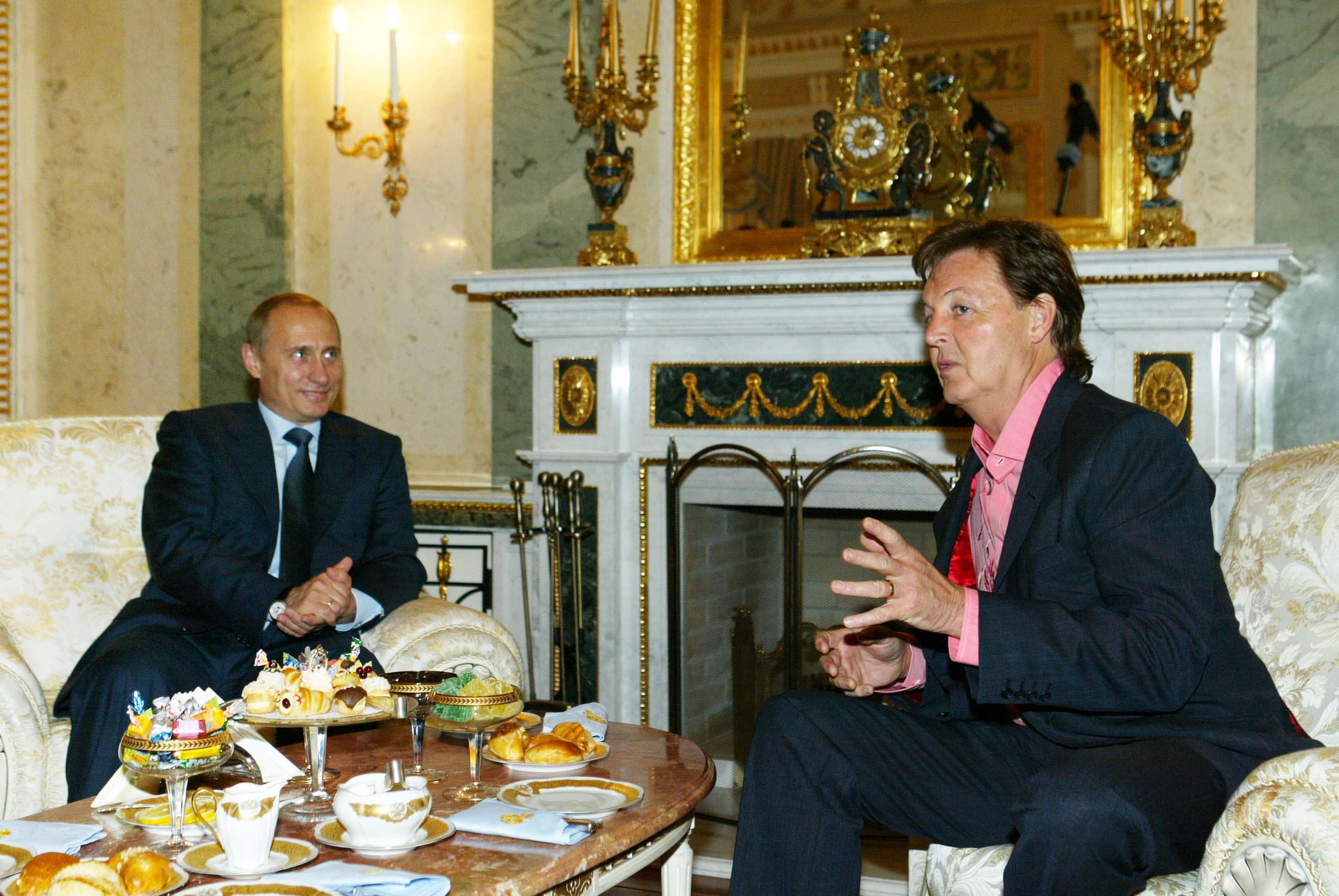 Russian President Vladimir Putin (L) listens to musician Sir Paul McCartney during their meeting at the Kremlin on May 24, 2003 in Moscow.