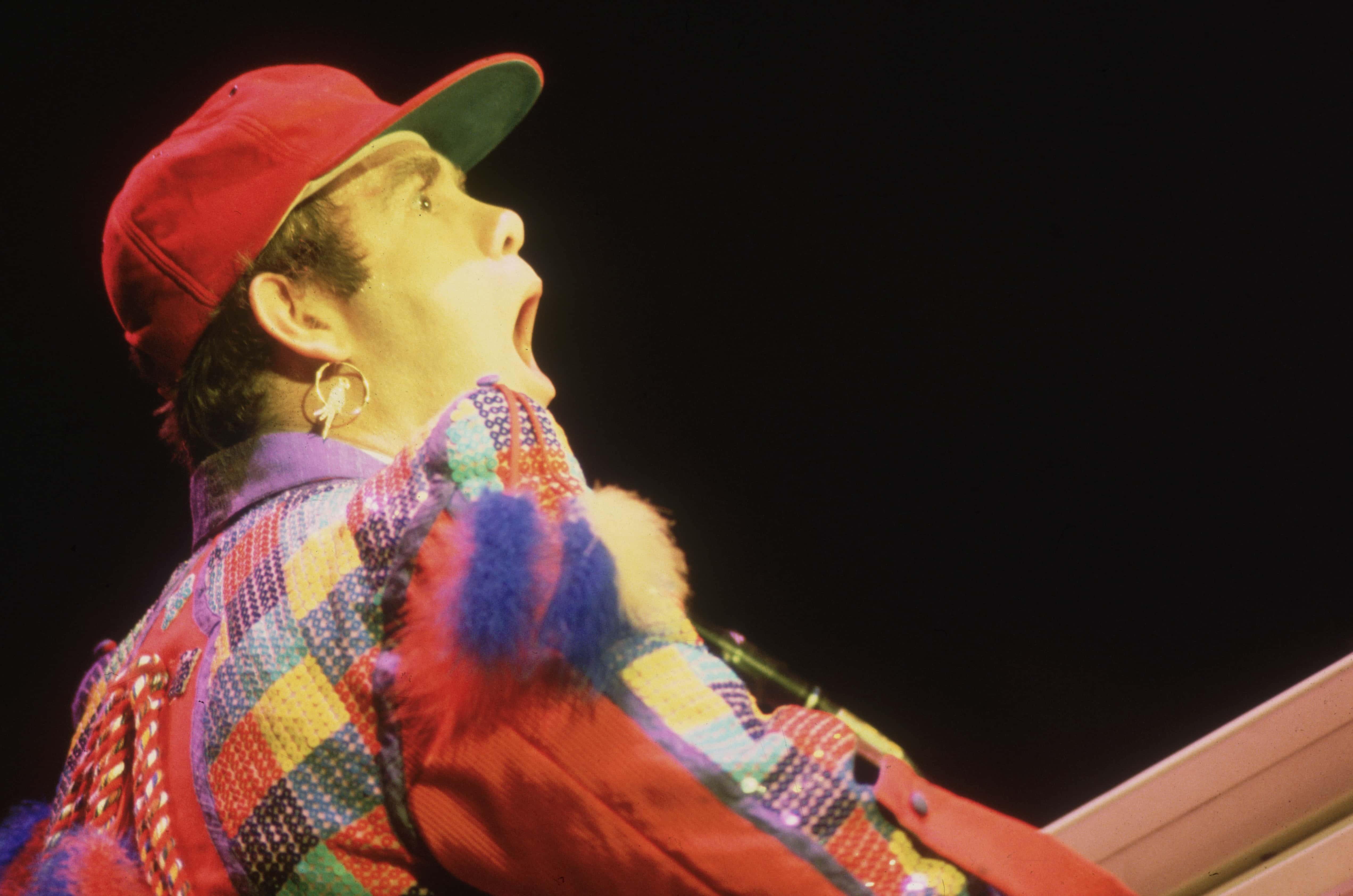 Elton John, performing in a colourful costume - 1982
