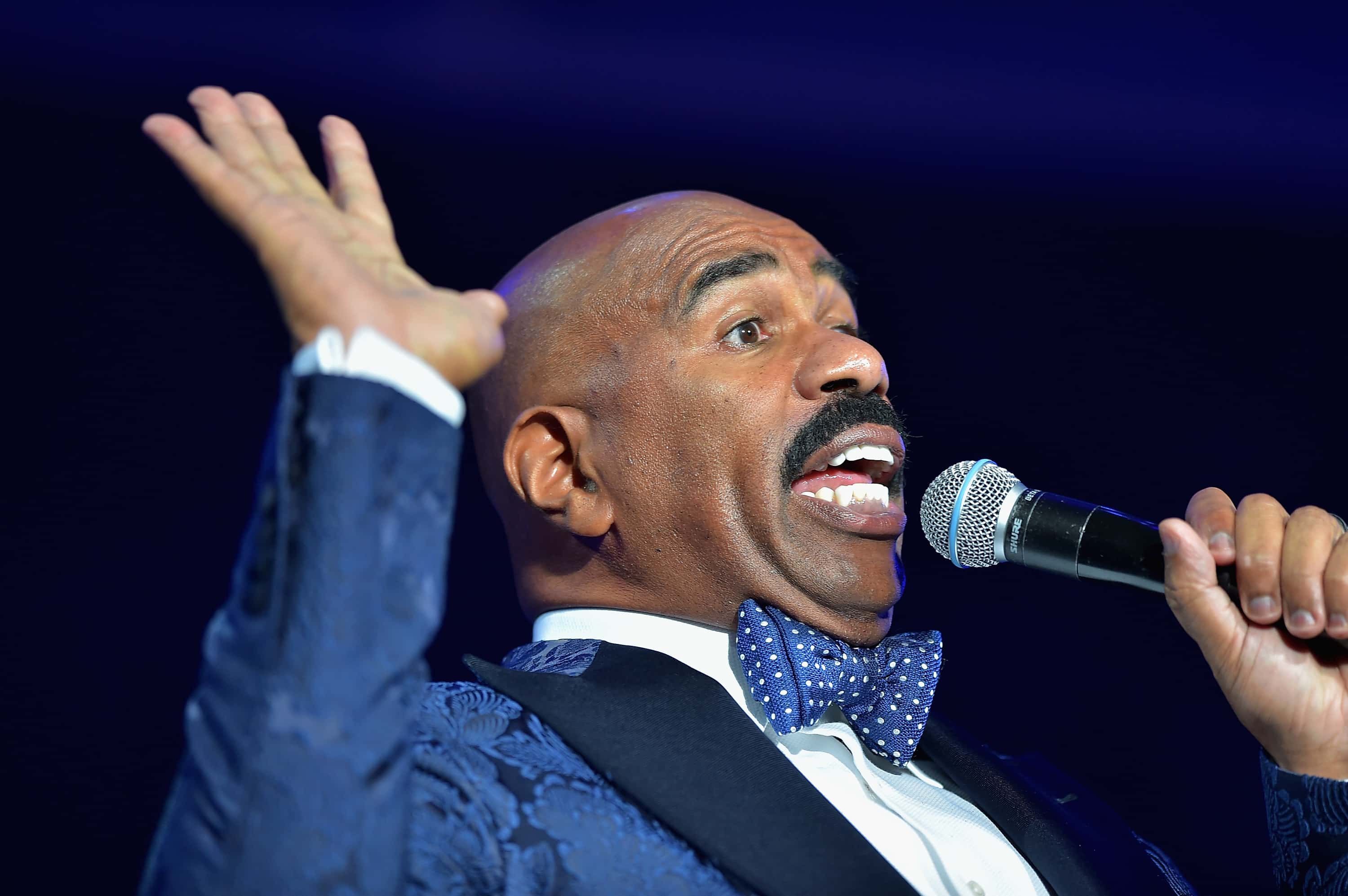 Steve Harvey holding a microphone