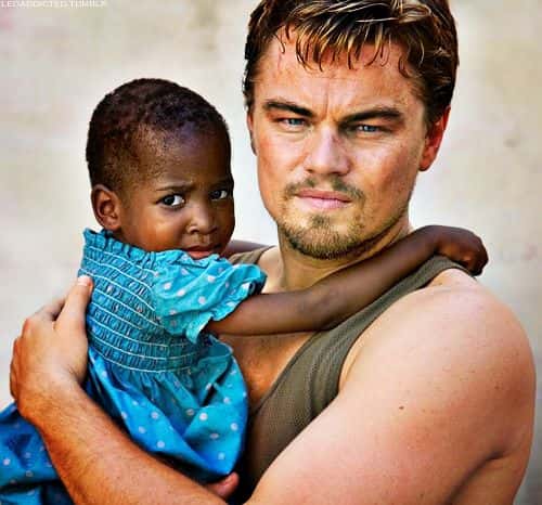 Leo Holding Child in Blood Diamond