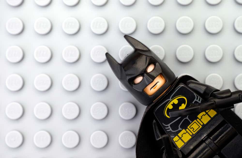 Lego Batman minifigure on Lego gray baseplate background