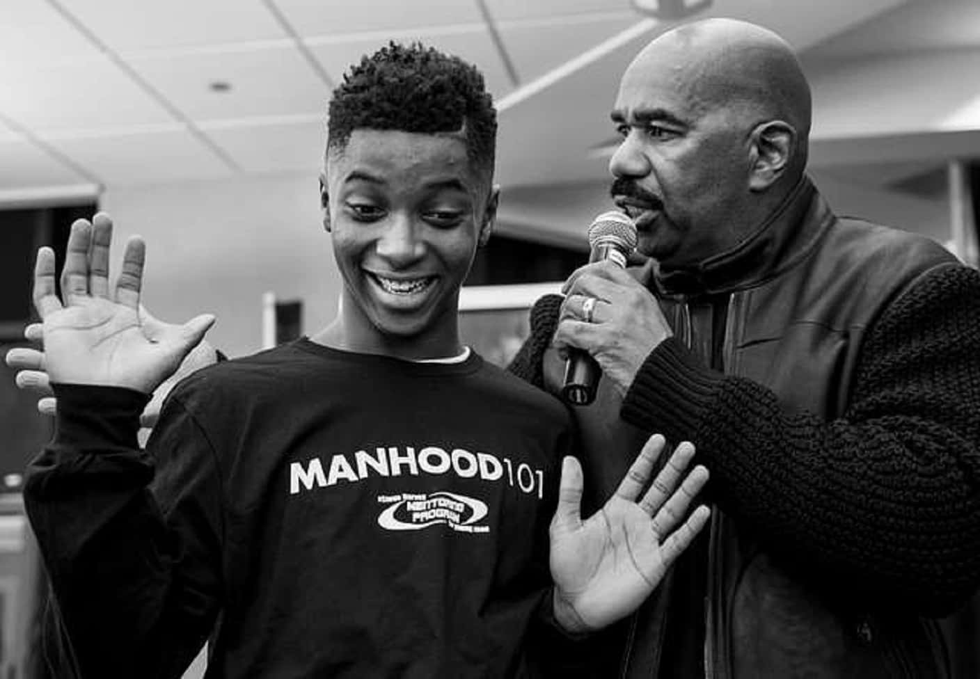 Steve Harvey talking with young man - 2015