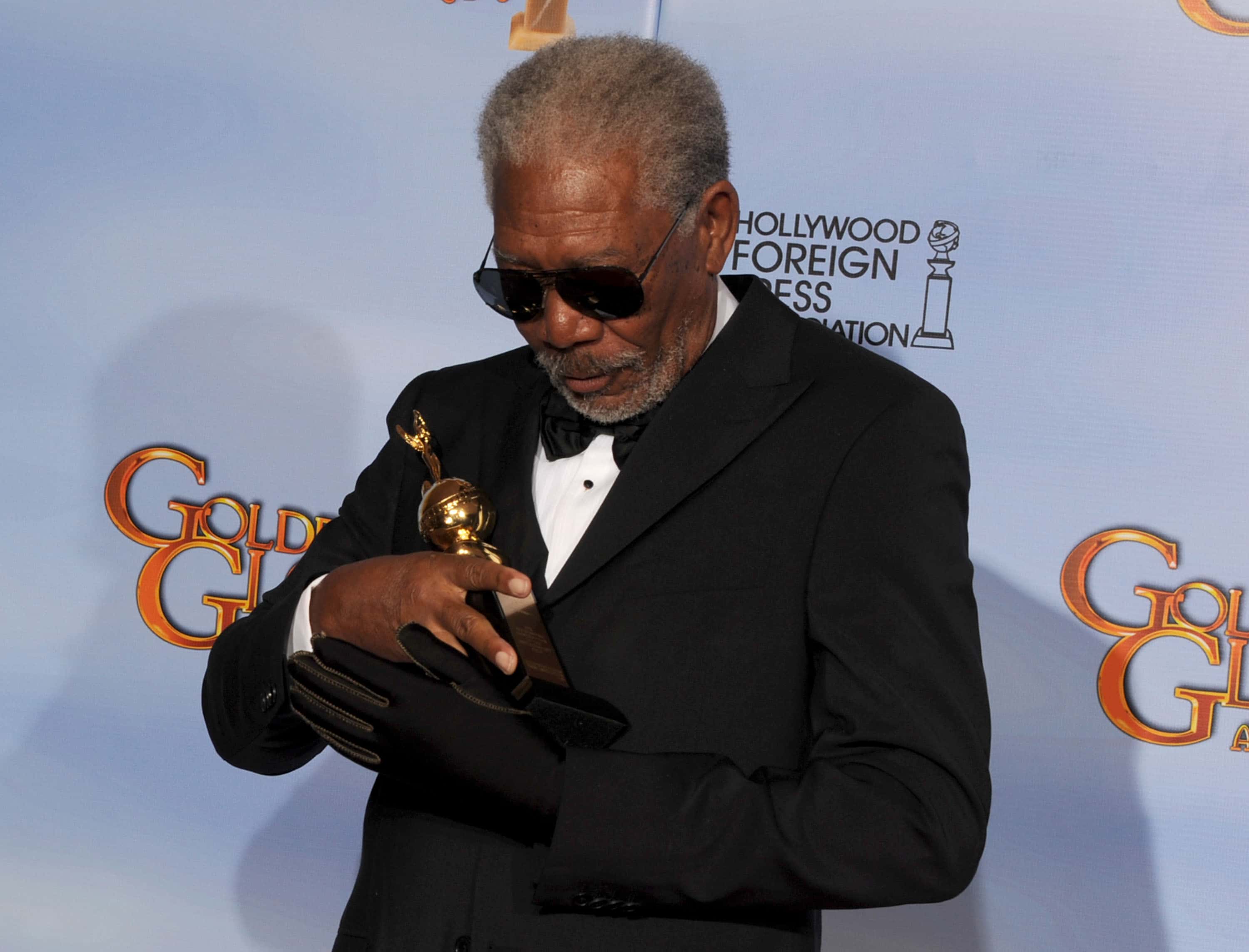 Actor Morgan Freeman poses in the press room with the Cecil B. DeMille Golden Globe award for career achievement