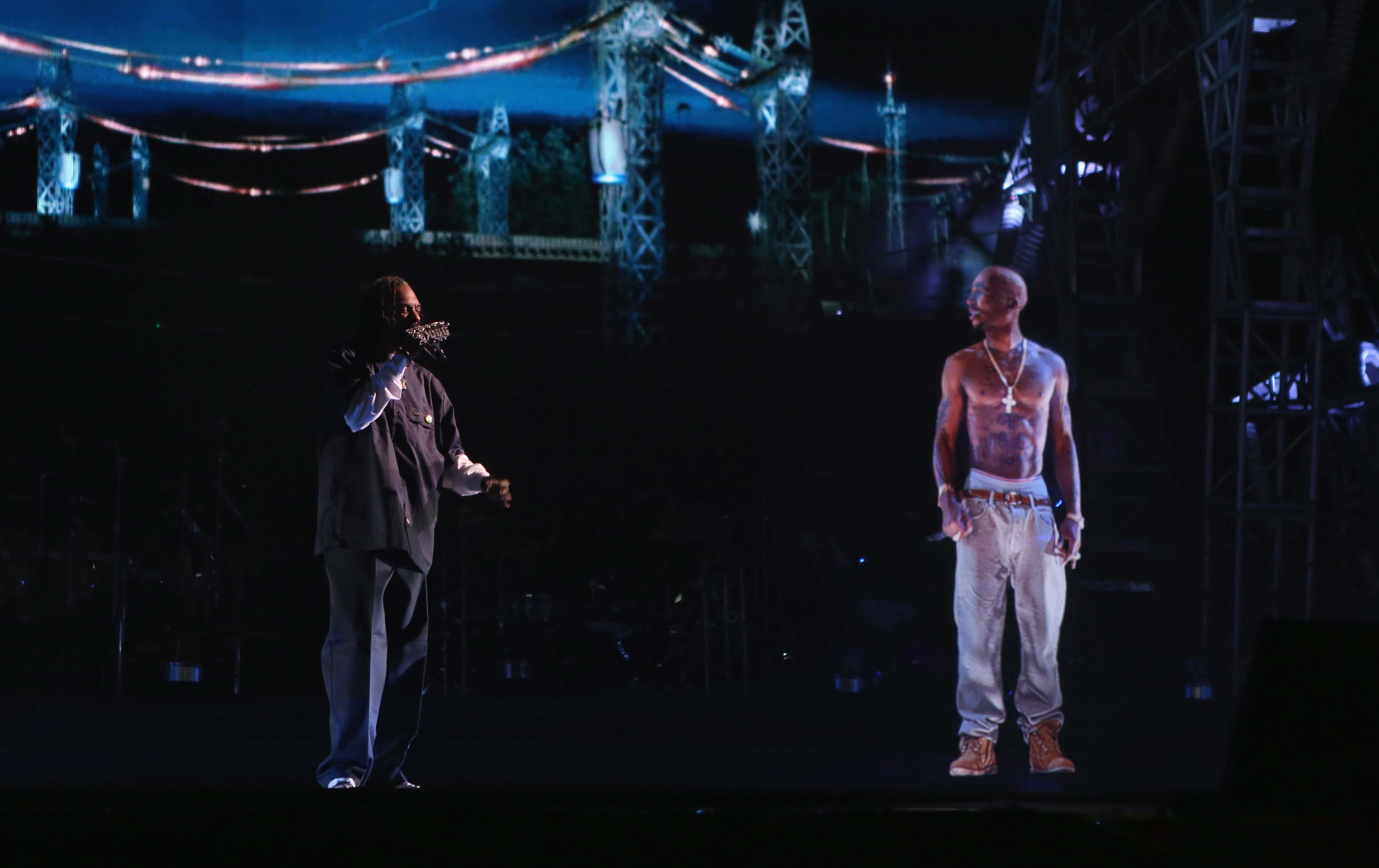 apper Snoop Dogg (L) and a hologram of deceased rapper Tupac Shakur