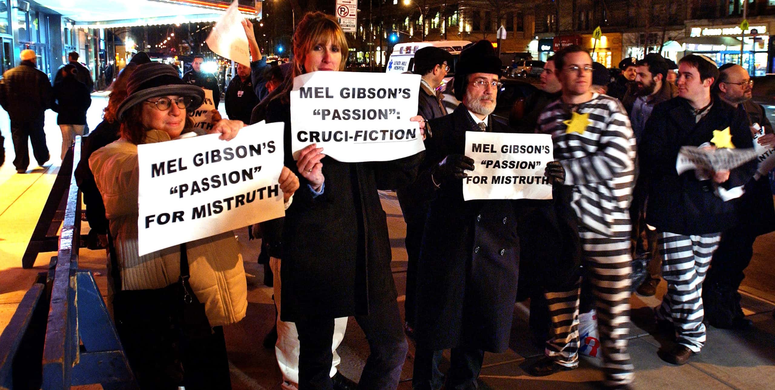 Demonstrators hold signs protesting Mel Gibson's The Passion of the Christ outside a movie theater February 25, 2004 in New York CIty