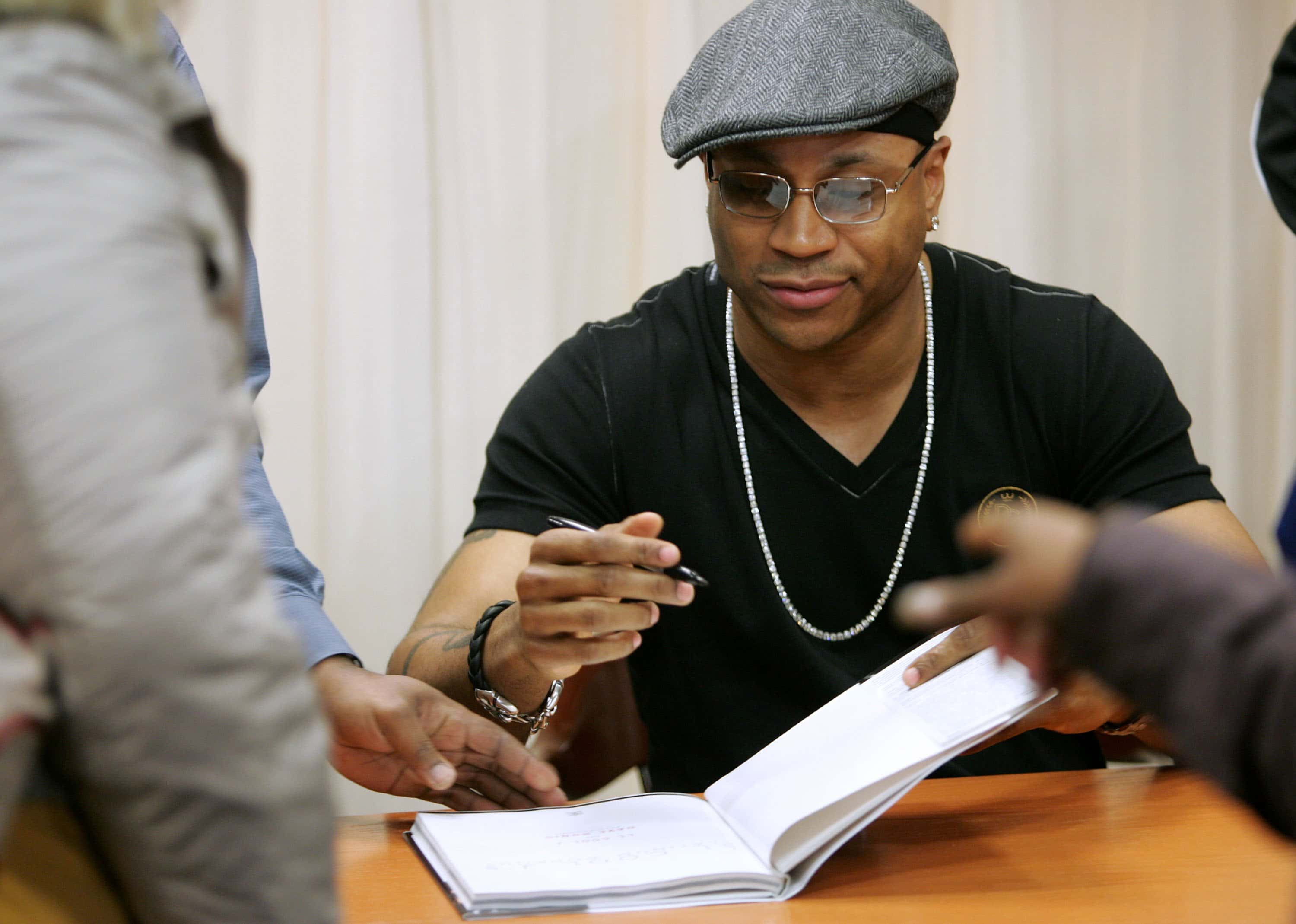 LL Cool J signing document