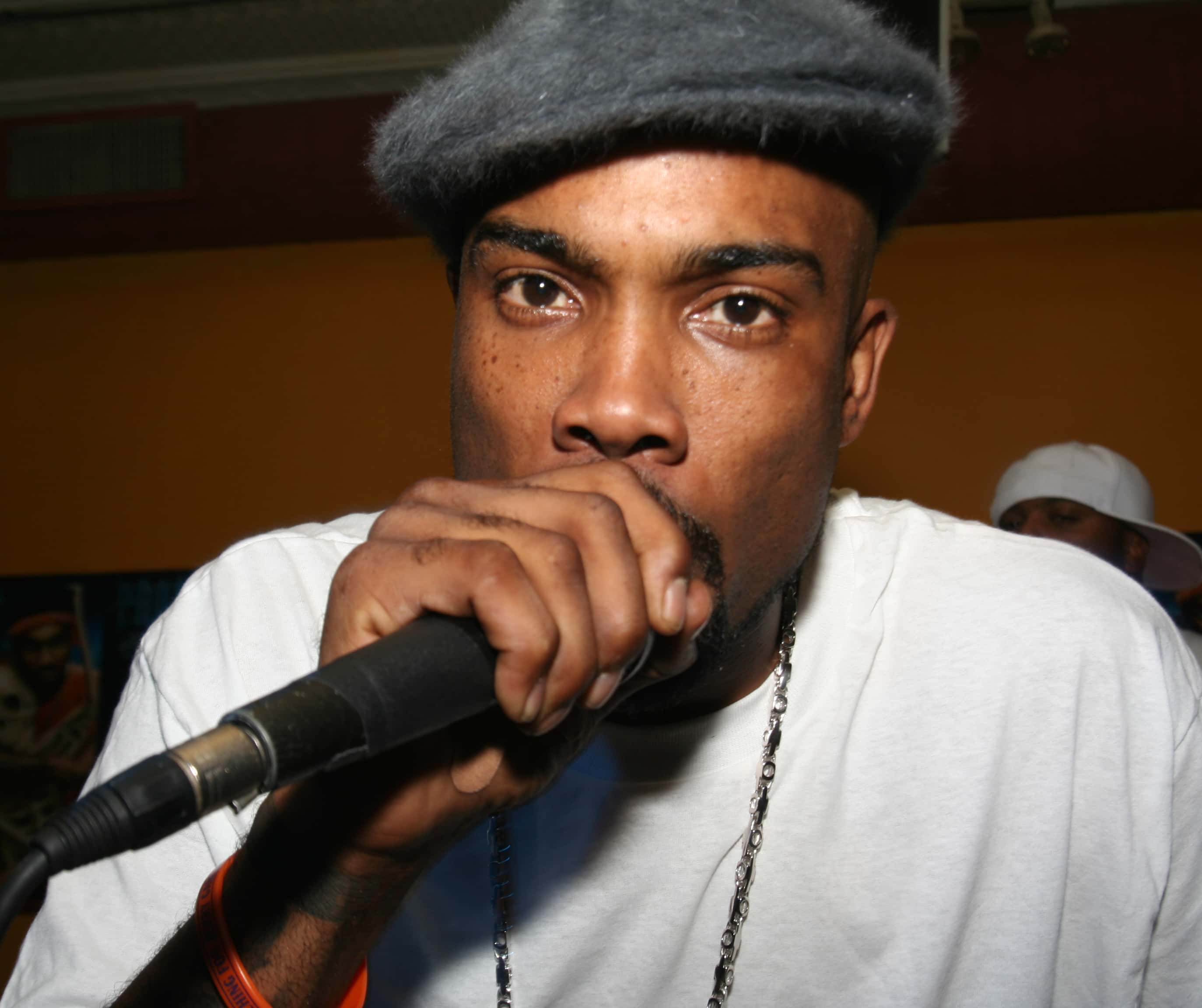 Proof (rapper) holding a microphone