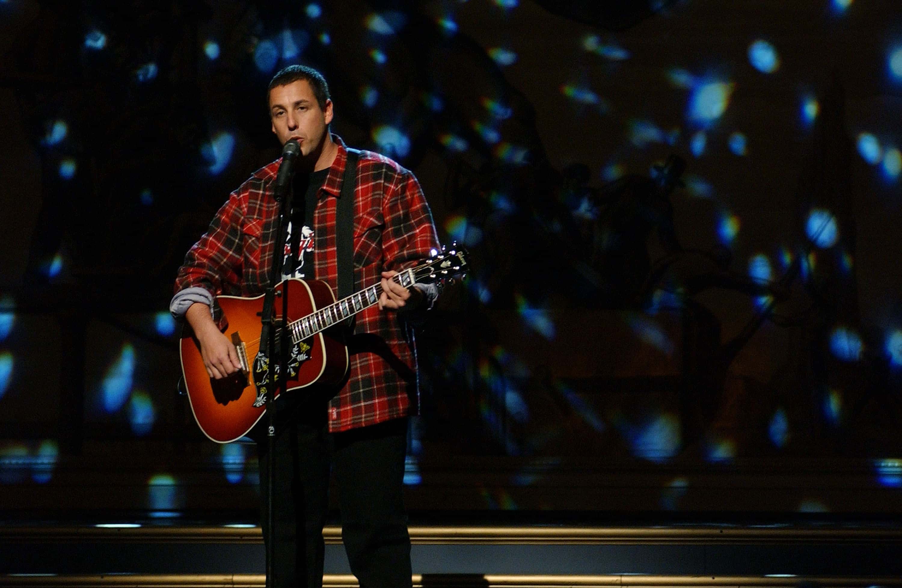 Actor Adam Sandler performs at the "Night of Too Many Stars", a gala event to benefit The Autism Coalition
