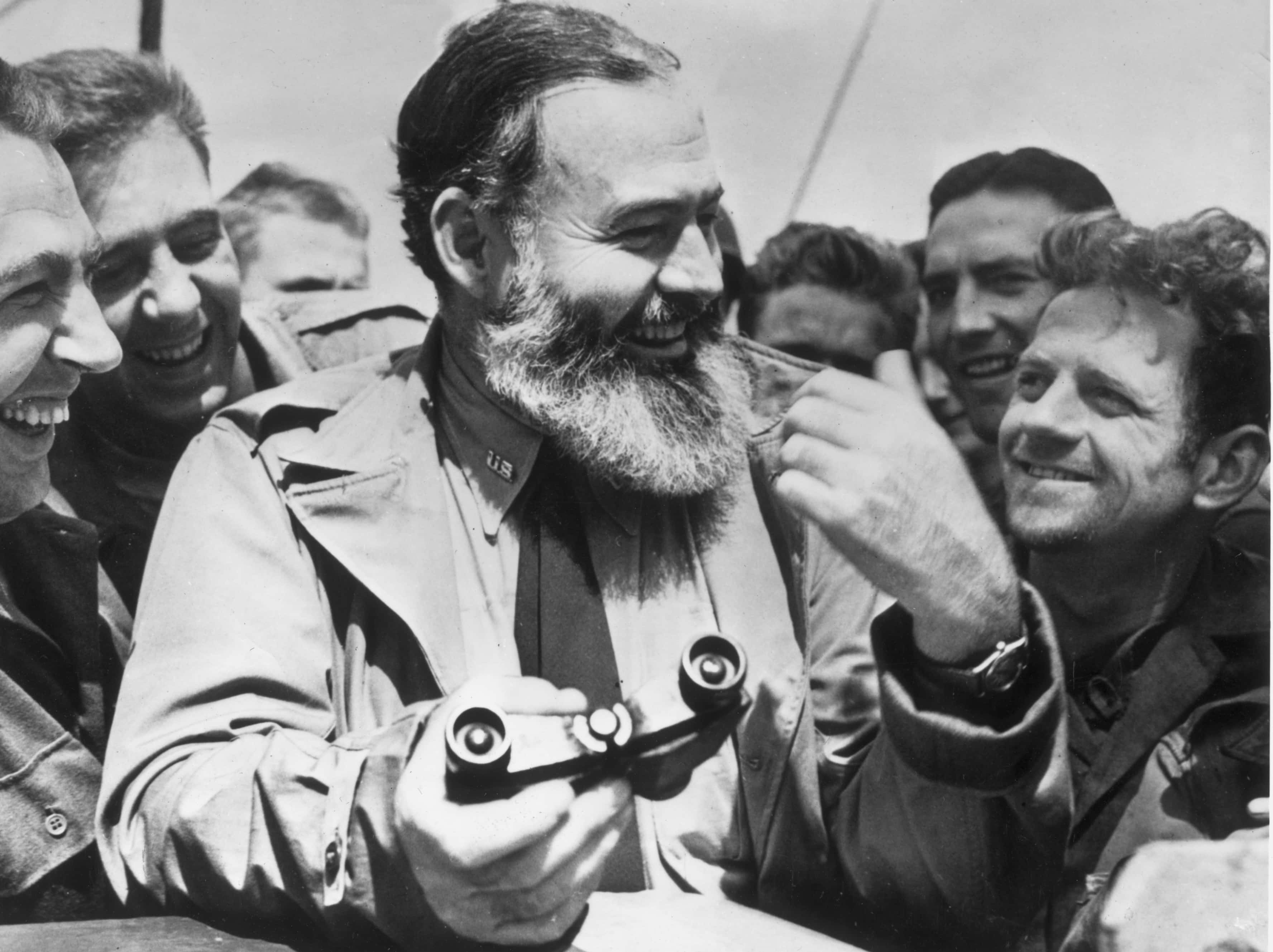 American writer Ernest Hemingway (1899 - 1961) travelling with US soldiers