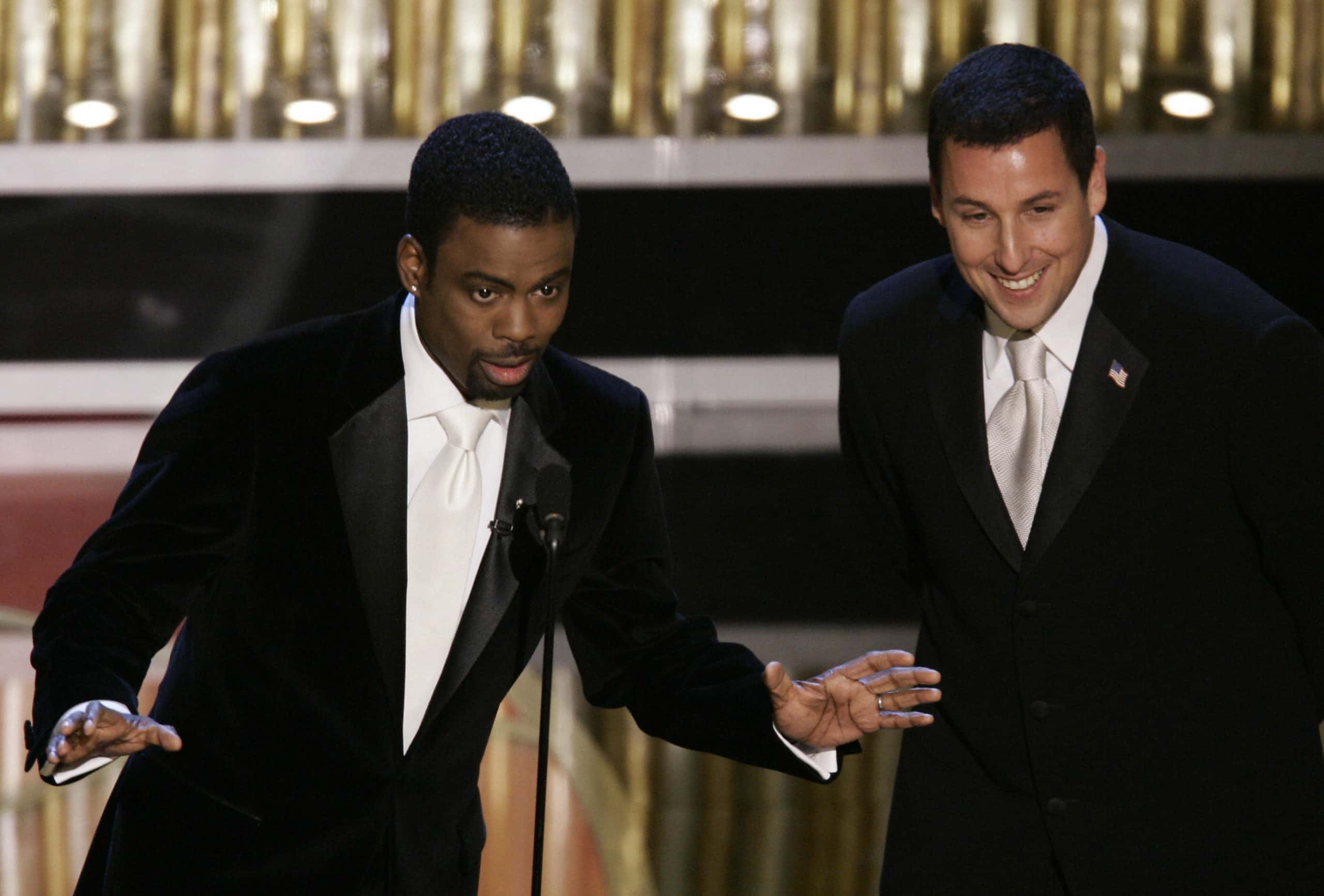 Chris Rock (L) and Adam Sandler at the 77th Academy Awards show