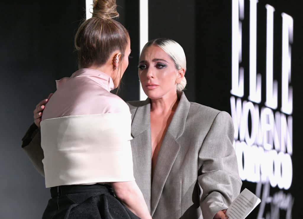 Jennifer Lopez (L) and Lady Gaga speak onstage - 2018